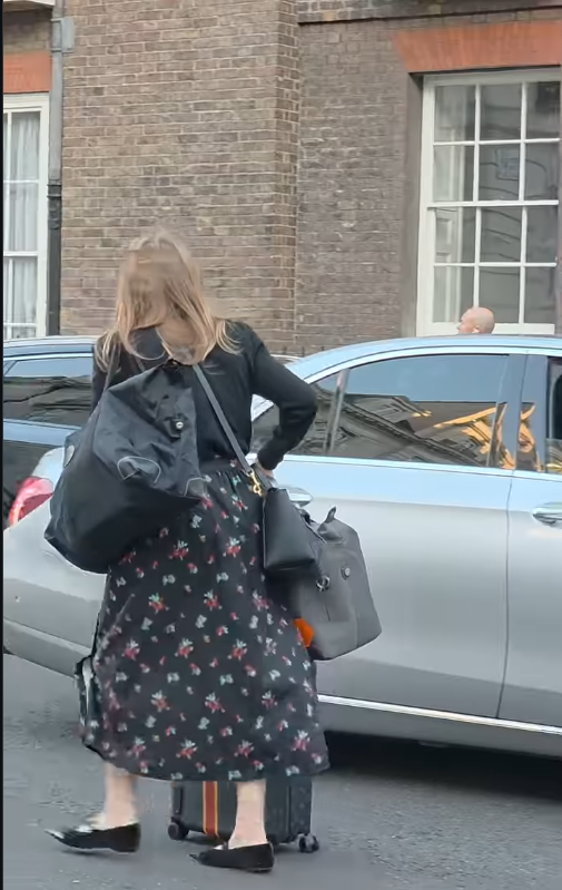 The mother of two proceeds to her waiting taxi | Source: Instagram/kingsguardchannel
