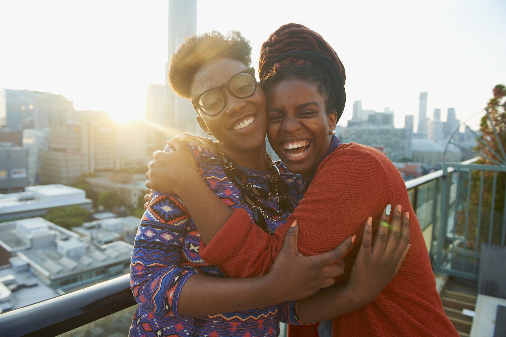 Sisters hugging on a rooftop in the city. | Photo: Getty Images