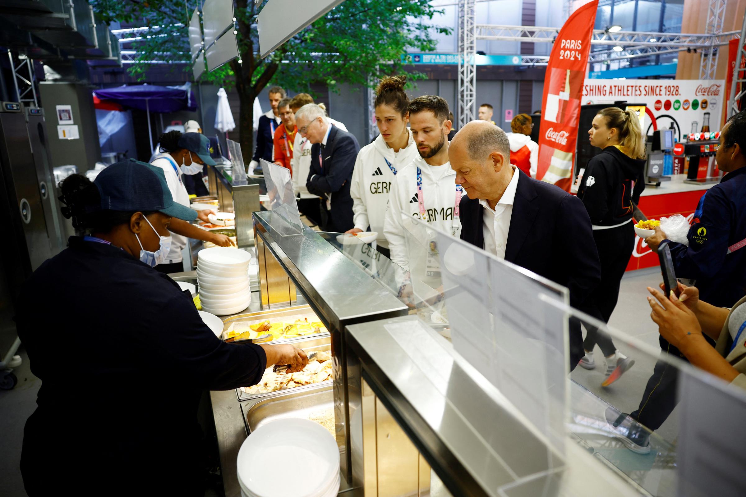 German Chancellor Olaf Scholz joins members of the German Olympic team in the canteen as he visits the German Olympic team at the Olympic Village on day one of the Olympic Games Paris 2024 on July 27, 2024 in Paris, France | Source: Getty Images