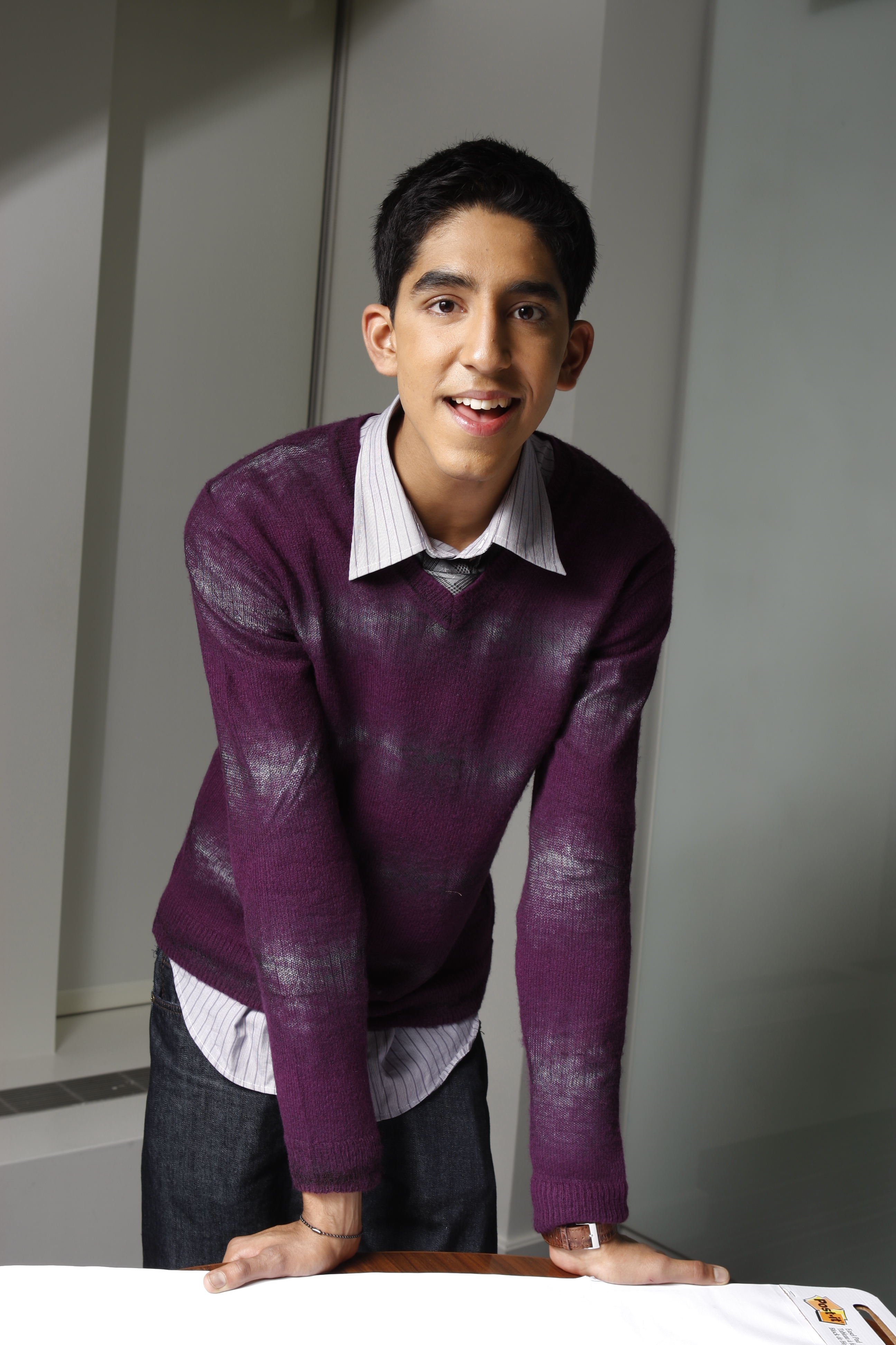 In 2008, Patel was an 18-year-old newcomer promoting "Slumdog Millionaire," the breakout film that would go on to win Best Picture. He wore a simple plum sweater layered over a collared shirt, with a shy grin that captured his fresh-faced innocence as he stepped into international fame almost overnight.
