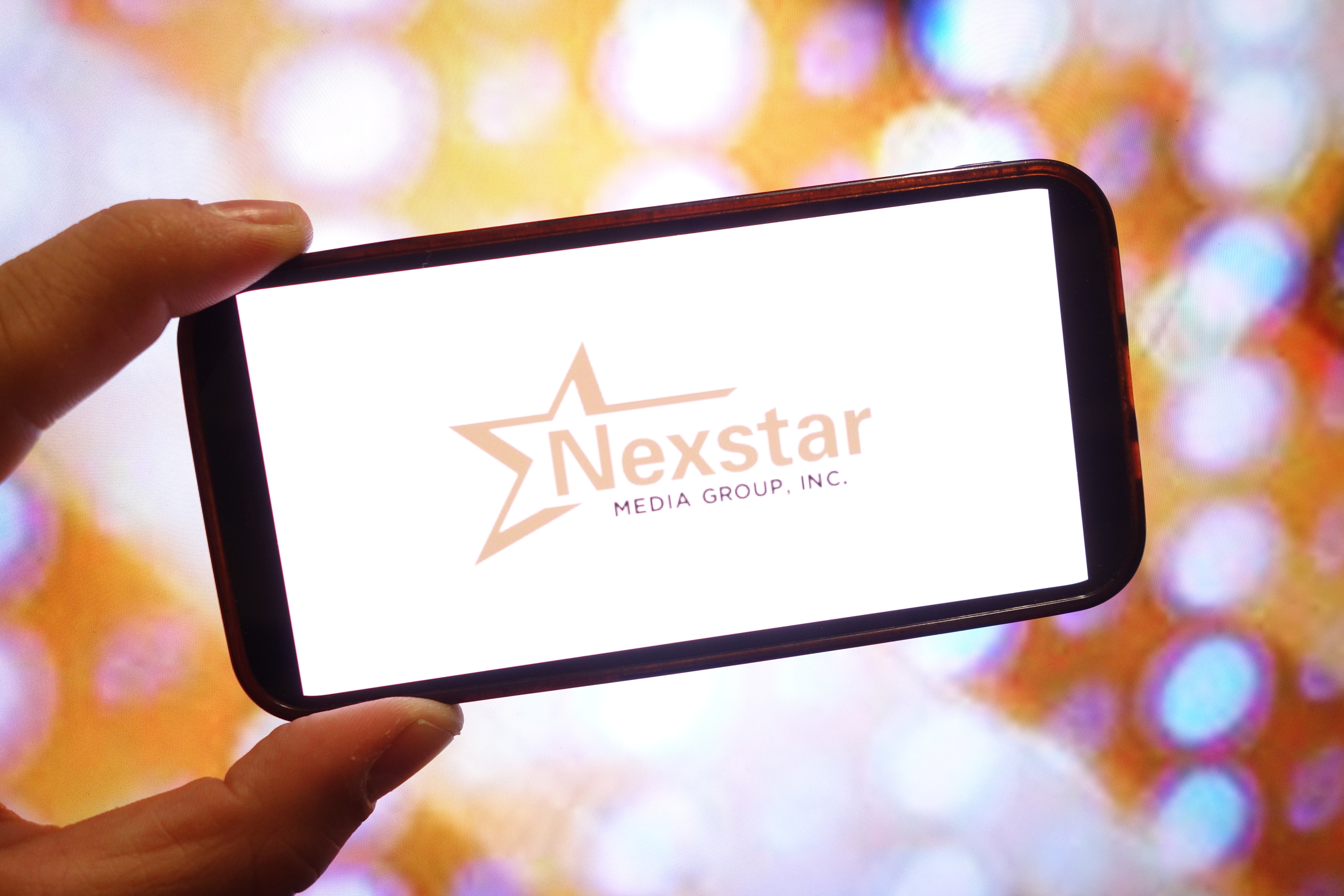 Nexstar Media Group company logo is seen displayed on a smartphone screen | Source: Getty Images
