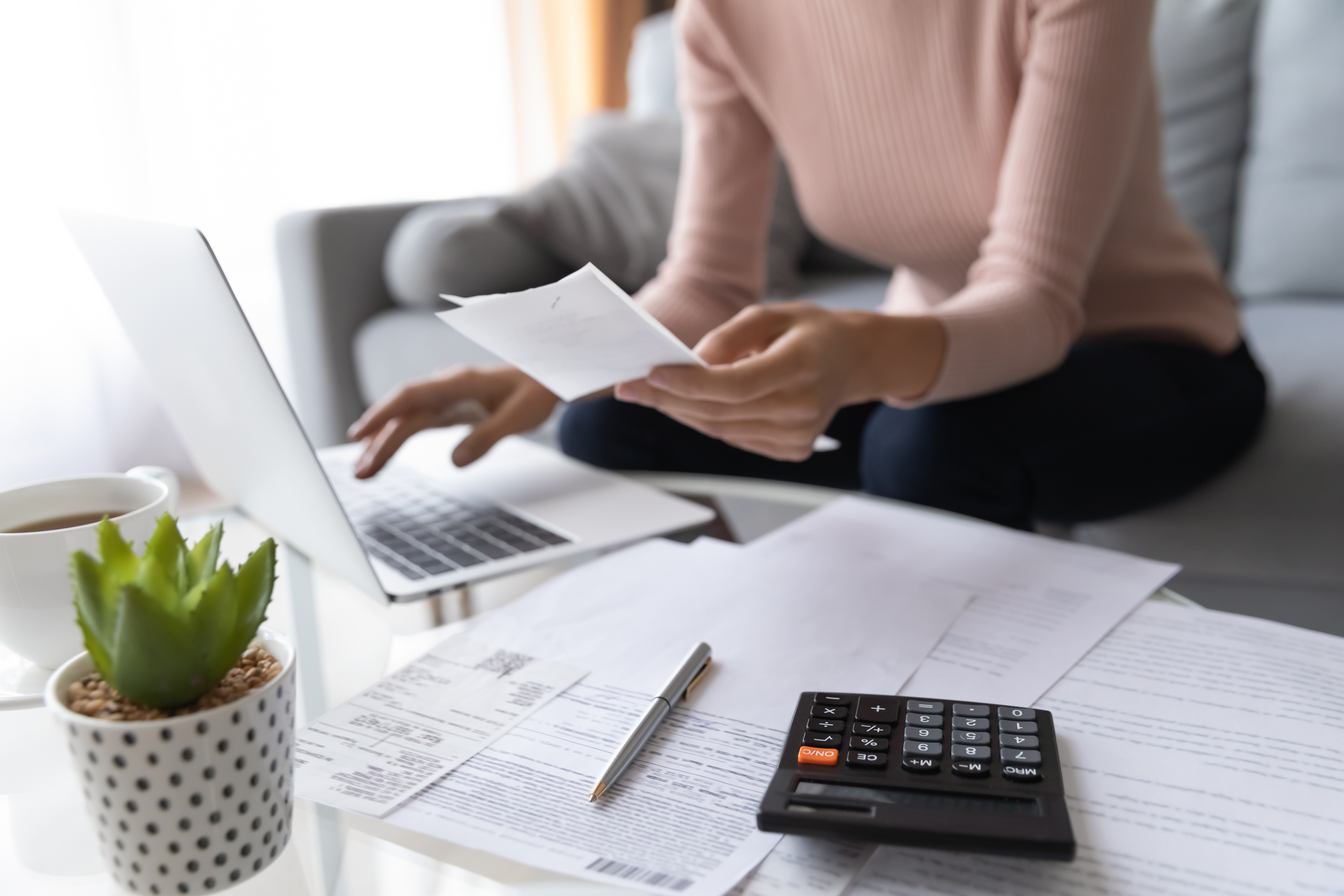 A woman calculating her finances | Source: Shutterstock