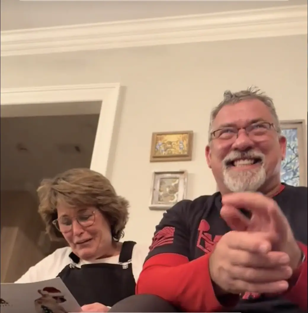 Ted Lawver laughing while sitting beside his wife | Source: TikTok/lindseyswagmom