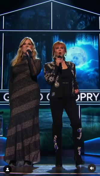 Trisha Yearwood and Reba McEntire perform onstage during Opry 100: A Live Celebration at Grand Ole Opry posted on March 20, 2025 | Source:  Instagram/nbc