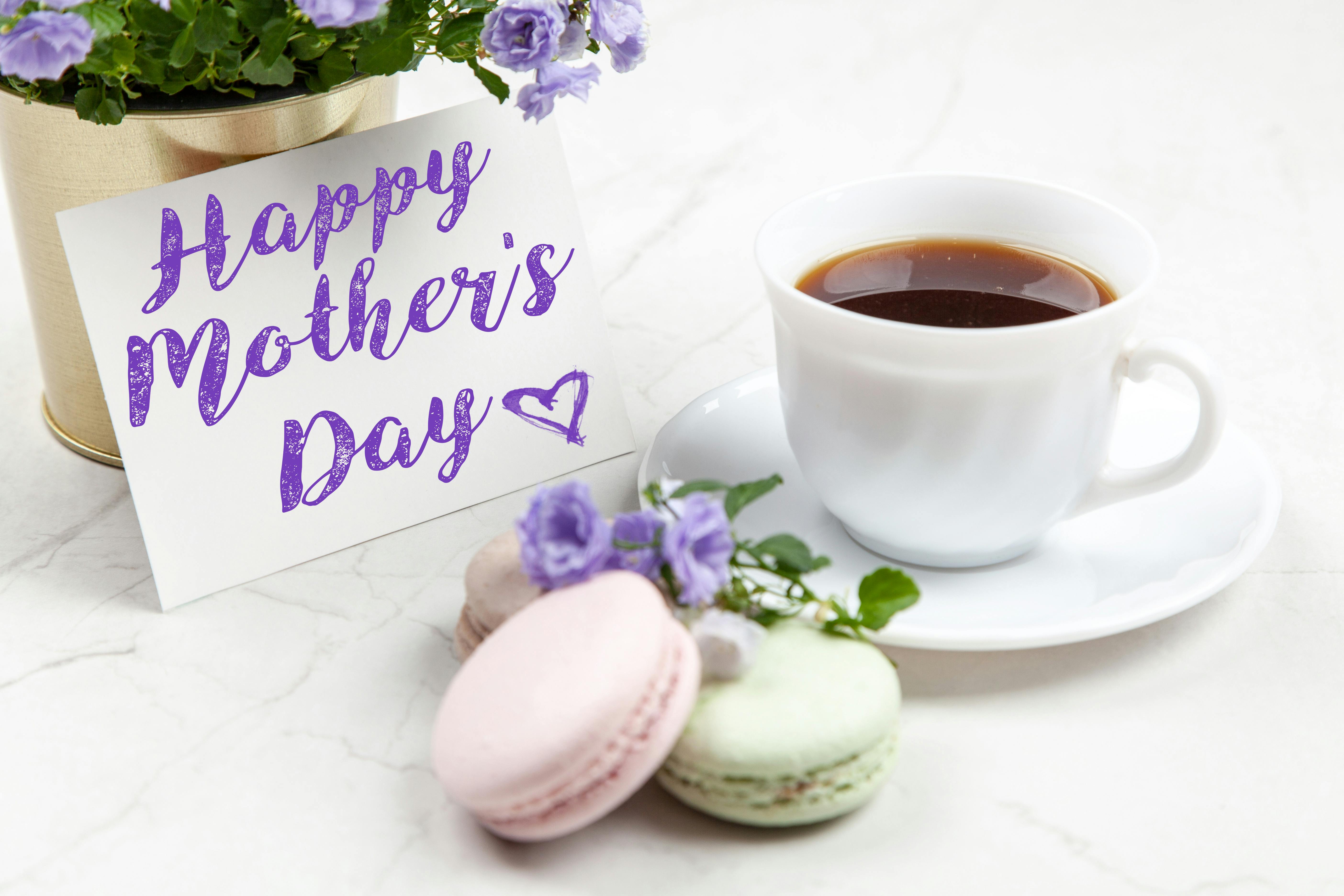 A Mother's Day card next to a cup of tea and macarons | Source: Pexels