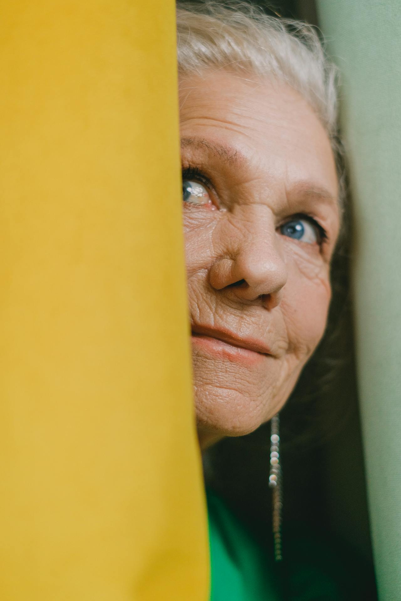 An older woman standing at the doorway | Source: Pexels