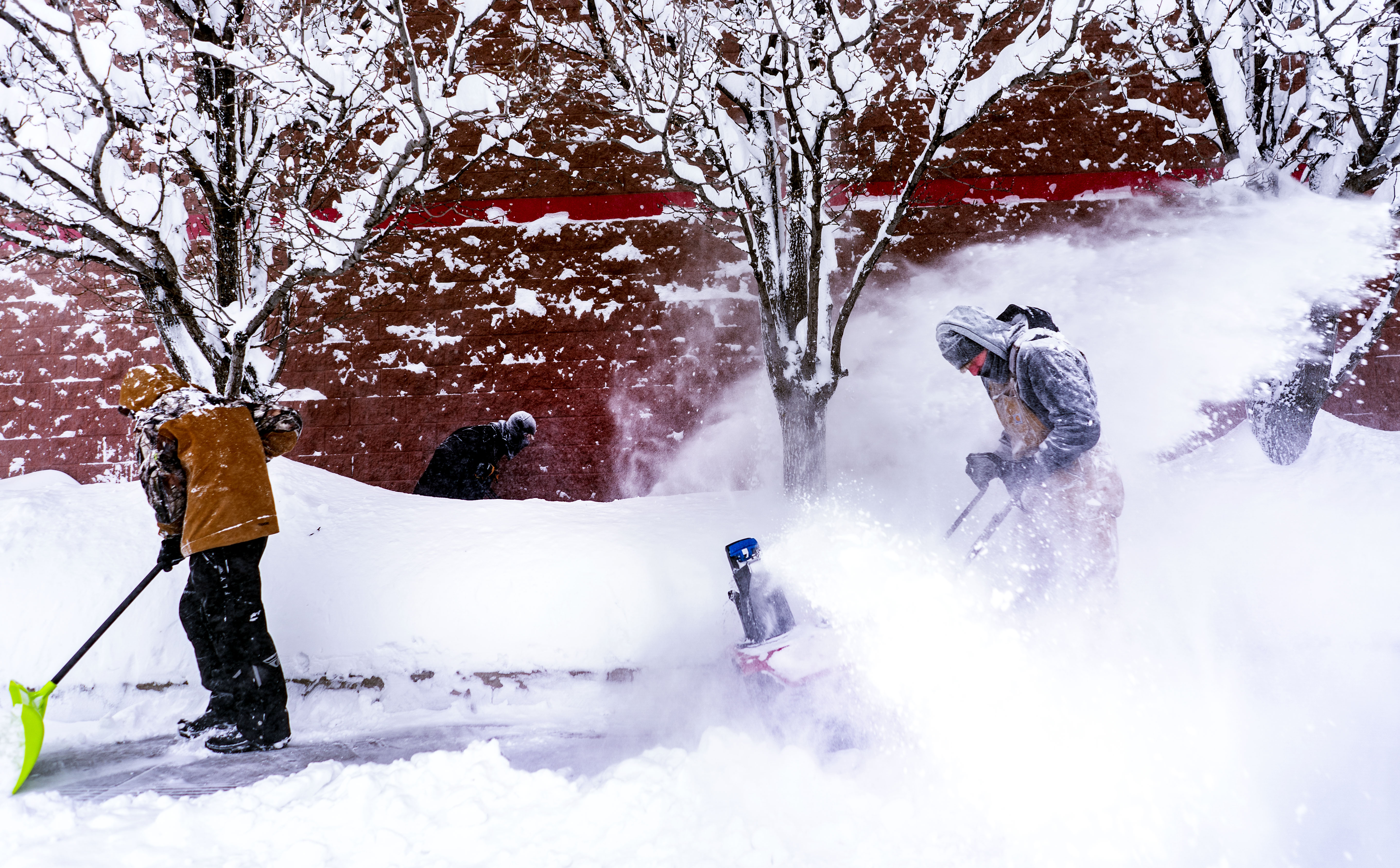 Iowans plow and shovel streets to stay ahead as a blizzard hits Iowa accompanied by high winds and freezing cold temperatures in Fort Dodge, Iowa on January 12, 2024. | Source: Getty Images