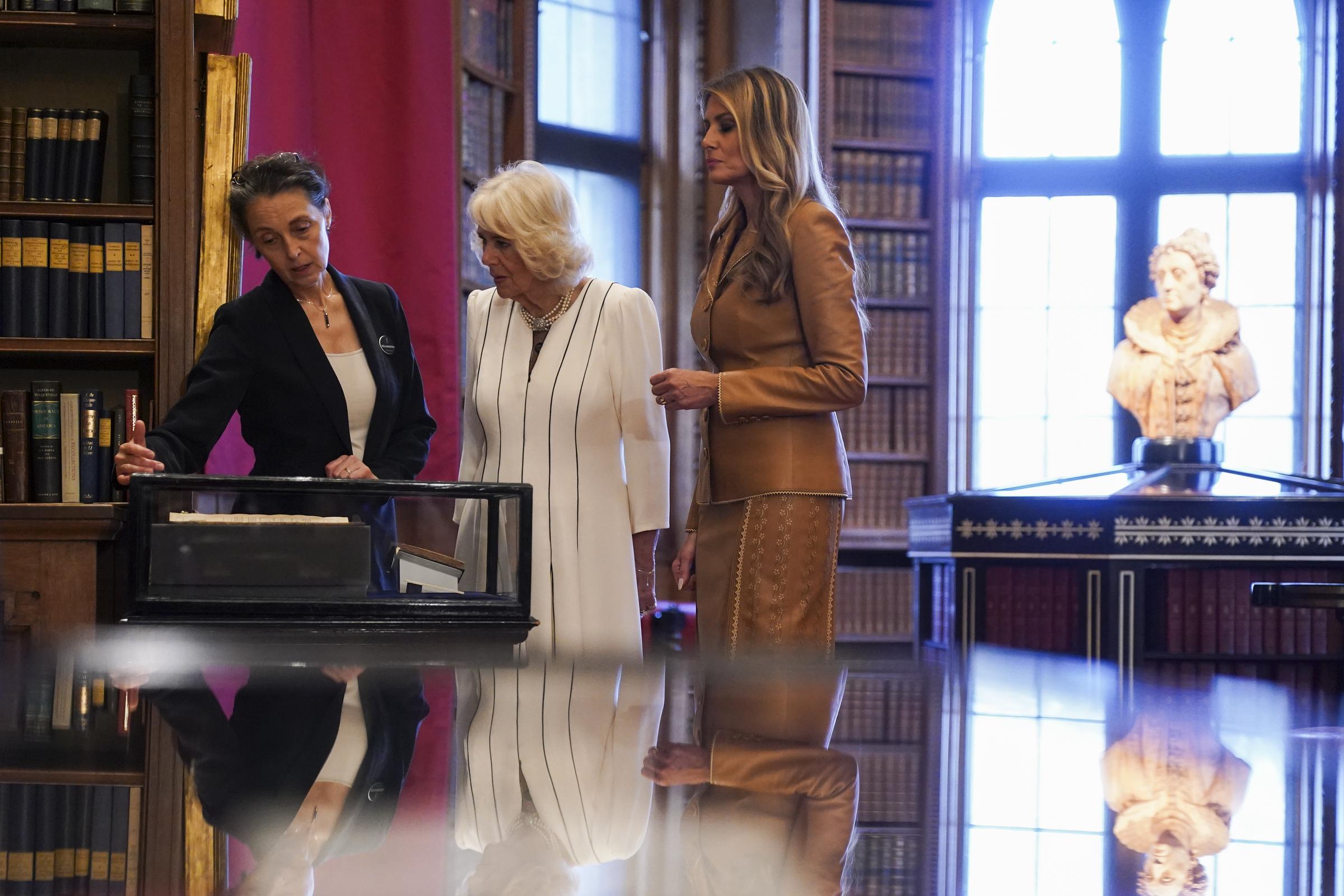 Queen Camilla and First Lady Melania Trump tour the Royal Library with Royal Librarian Stella Panayotova  in Windsor, England on September 18, 2025 | Source: Getty Images