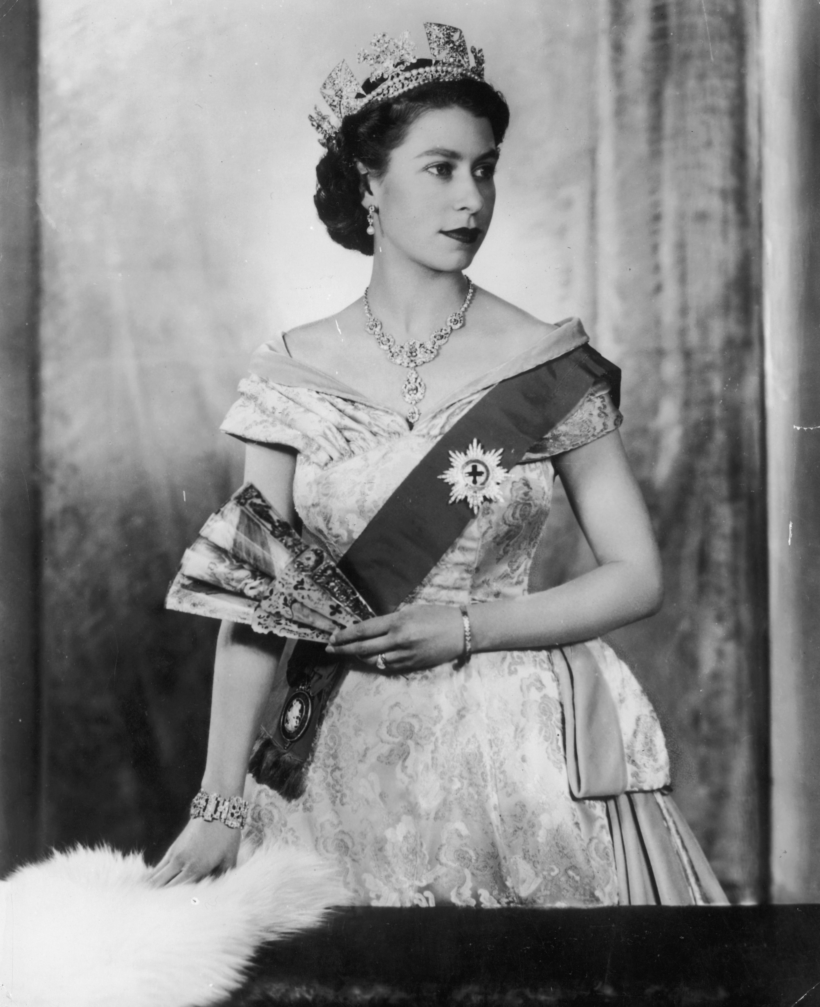 Queen Elizabeth II in her royall attire wearing a diamond bracelet gifted to her by Prince Phillip in circa 1955. | Source: Getty Images 