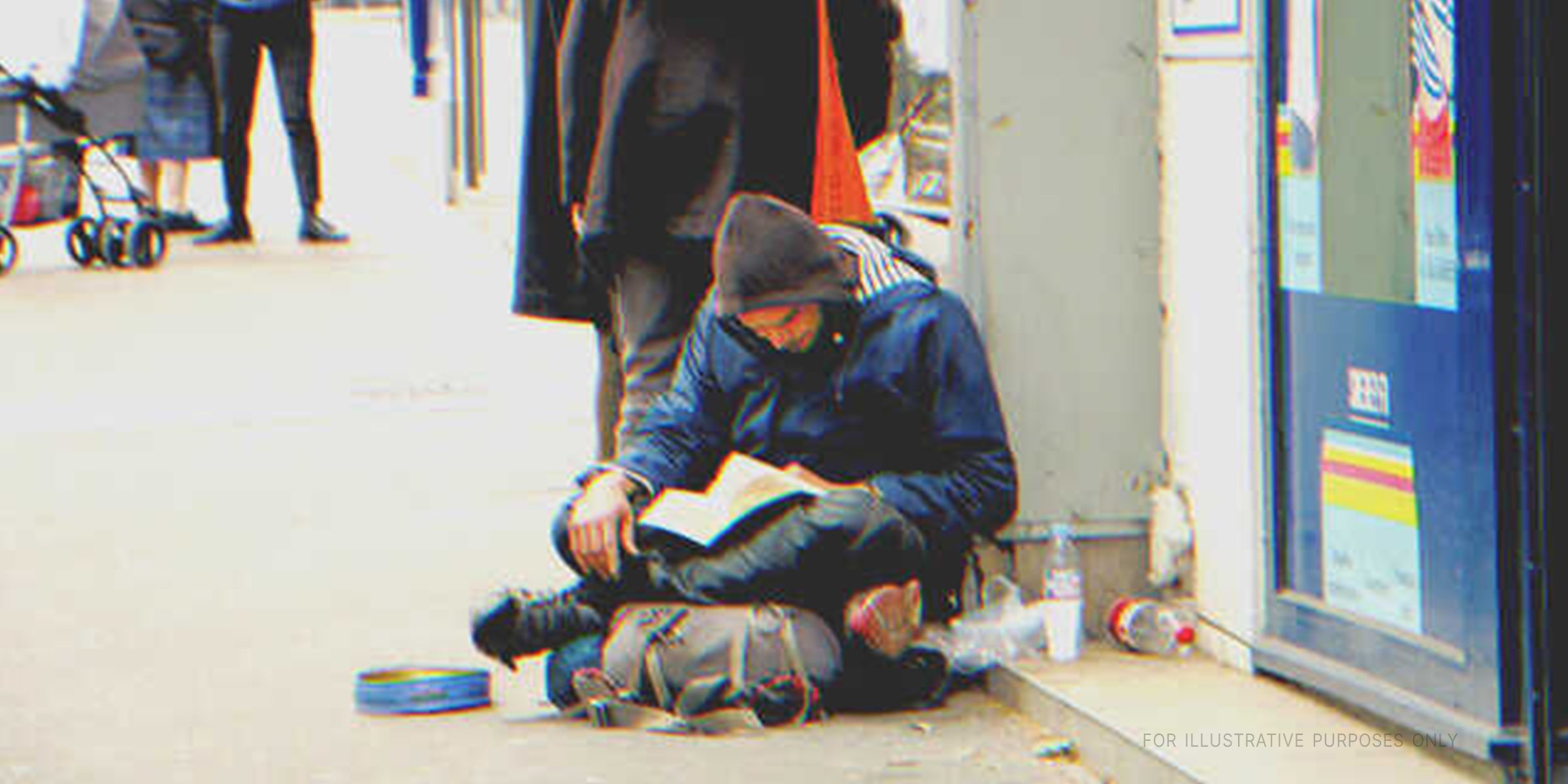 A homeless man reading a book | Source: Shutterstock