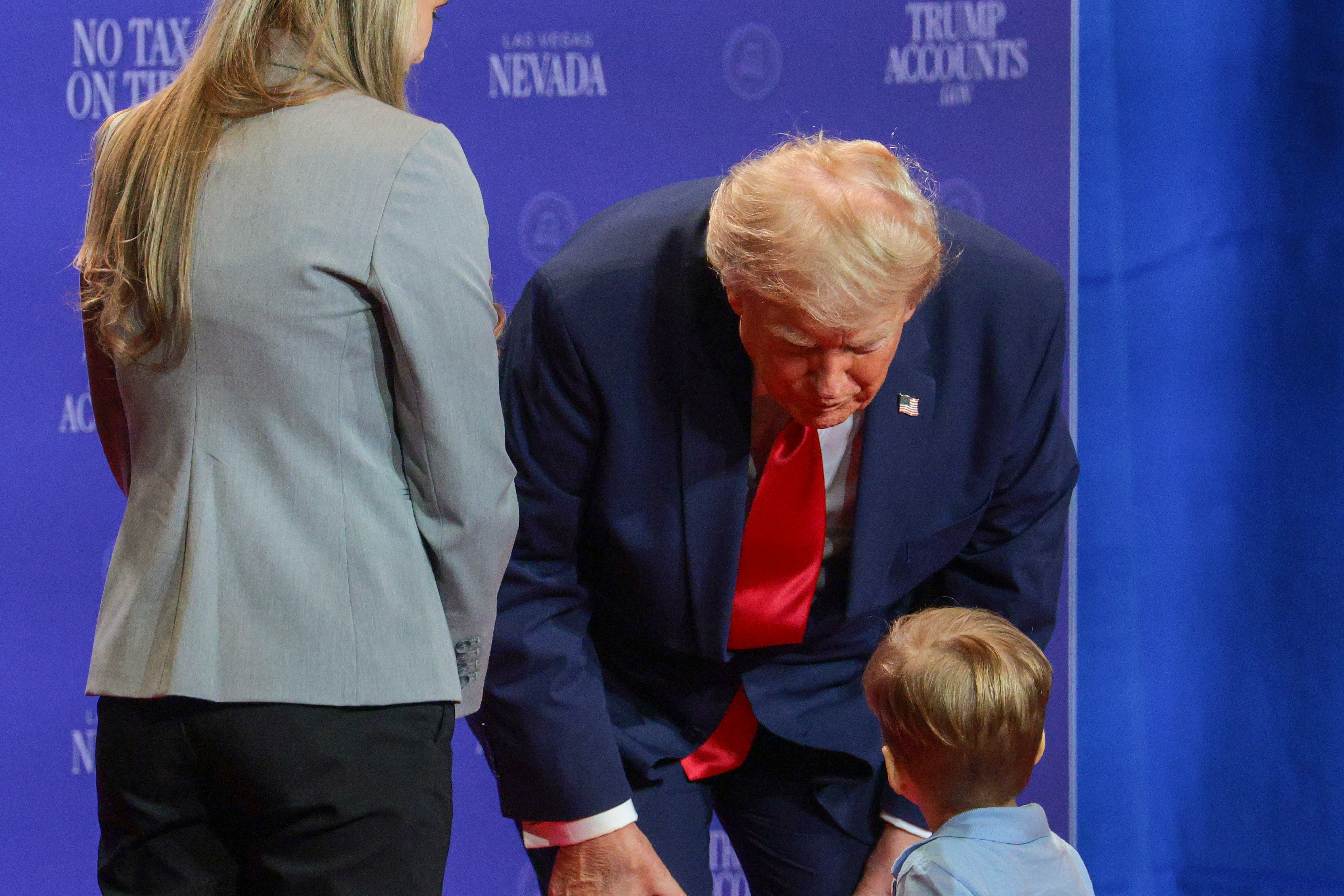 Donald Trump helped the boy on stage before the child took the microphone. In this photo, he greeted the young guest during an event at Red Rock Casino Resort and Spa on August 5, 2026, in Las Vegas, Nevada. | Source: Getty Images