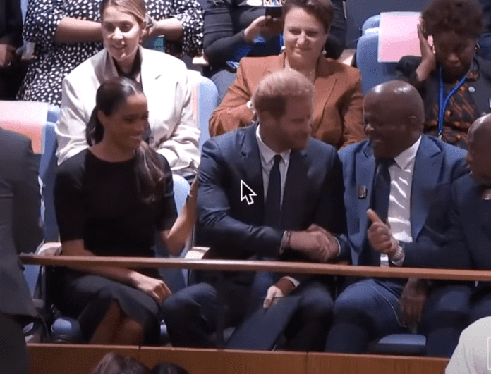 Meghan Markle attempting to get Prince Harry's attention while he engages with another guest at the General Assembly during the Nelson Mandela International Day at the United Nations Headquarters on July 18, 2022 in New York City.┃Source: YouTube/@TheBodyLanguageGuy