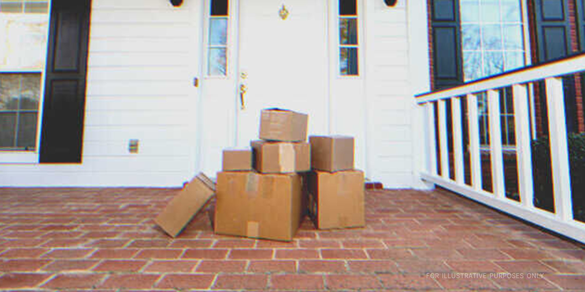 A stack of cardboard boxes on doorstep | Source: Shutterstock