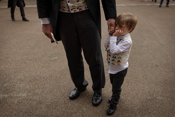 A boy and his dad wearing matching waistcoats  | Photo: Getty Images