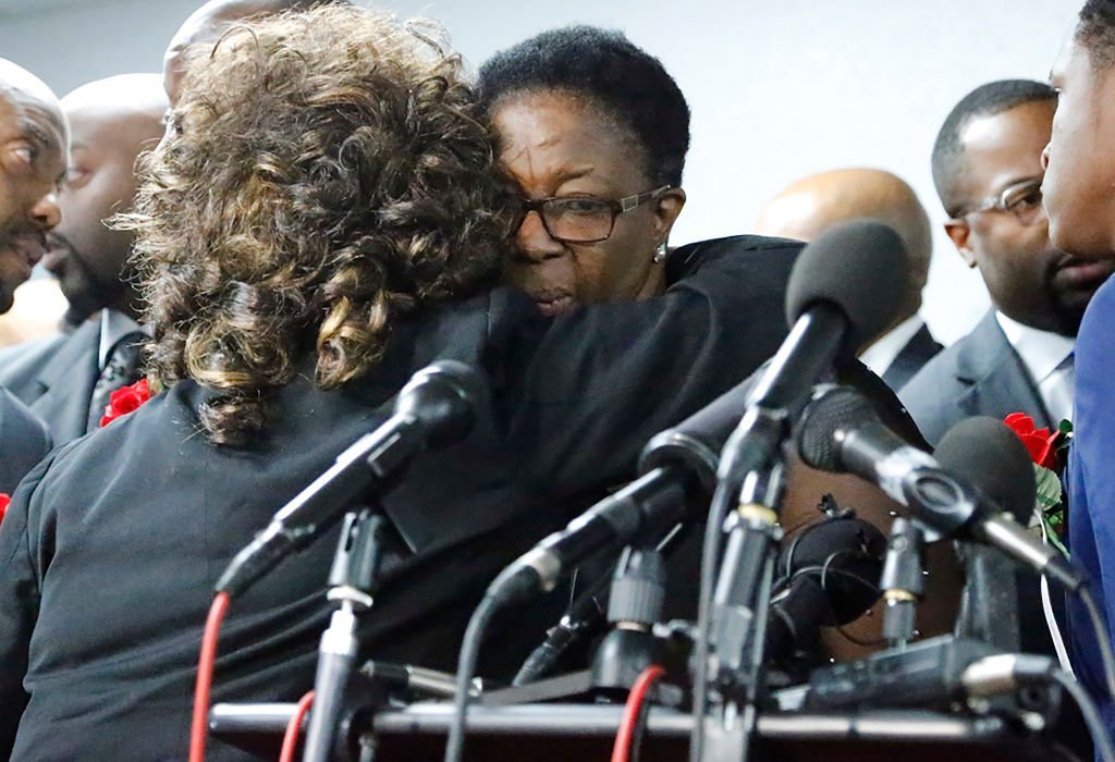Allison Jean, mother of Botham Shem Jaen, is embraced by a supporter after a press conference at Greenville Avenue Church of Christ | Photo: Getty Images