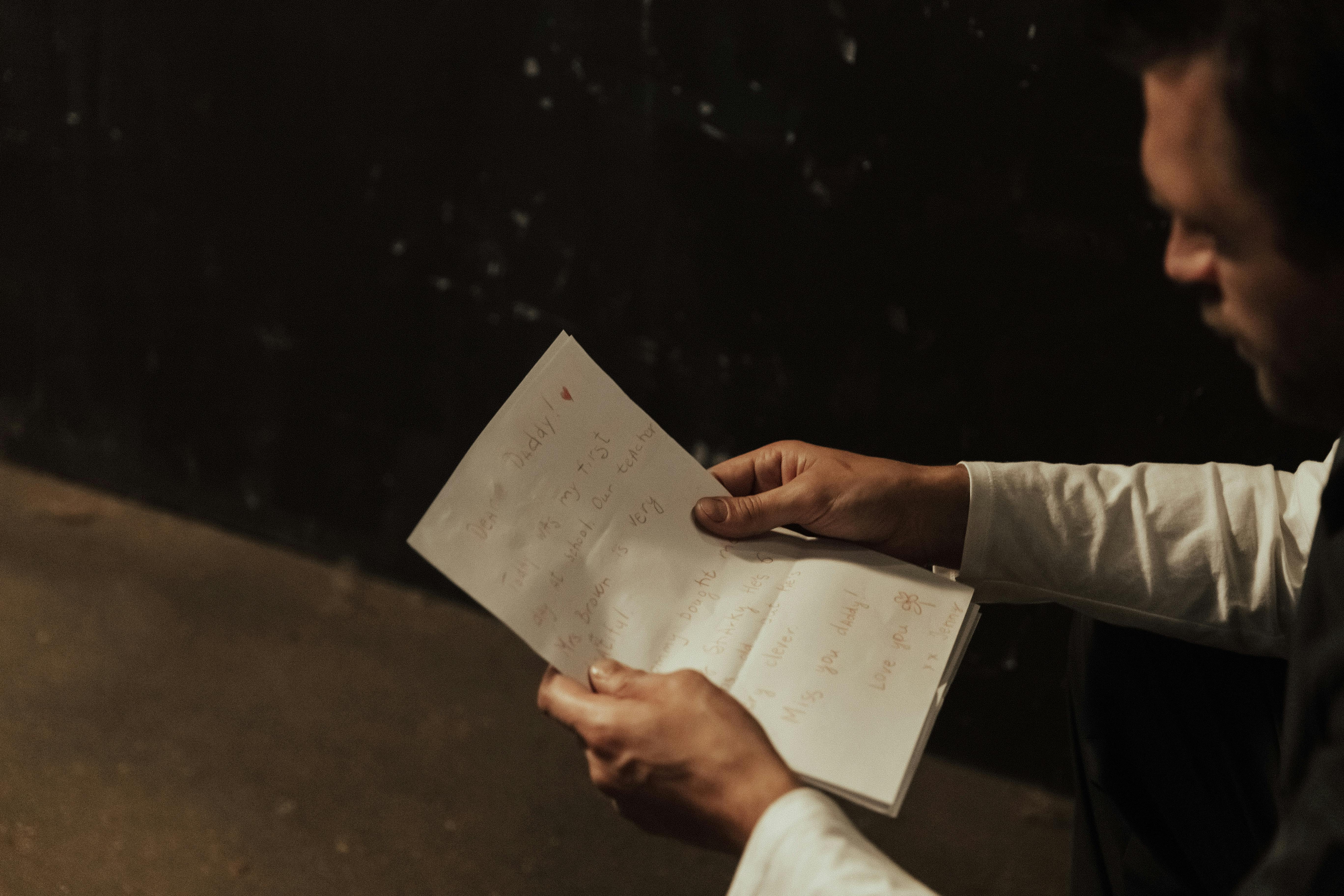 A man reading a handwritten note