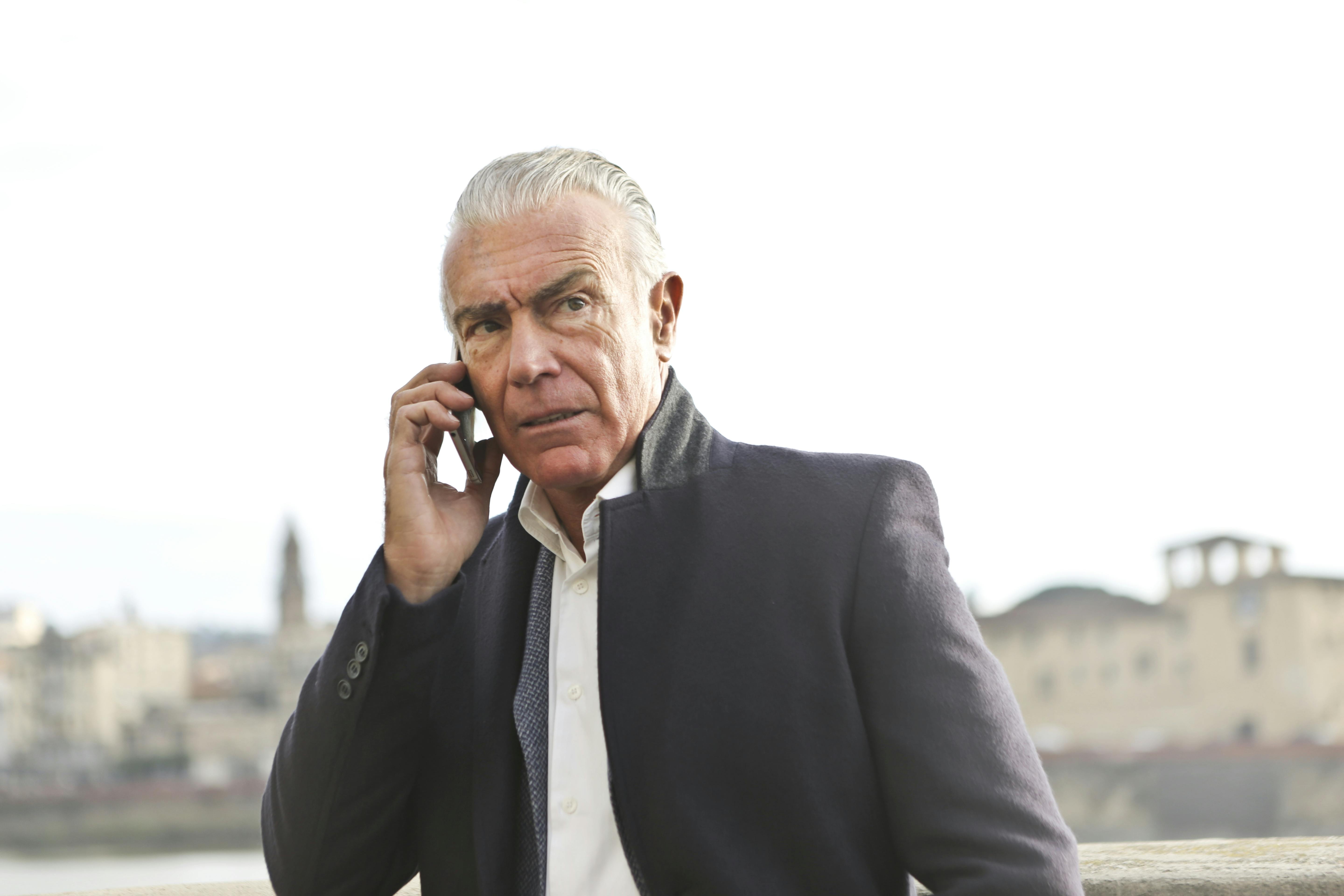 An unhappy man listening to something on his phone | Source: Pexels