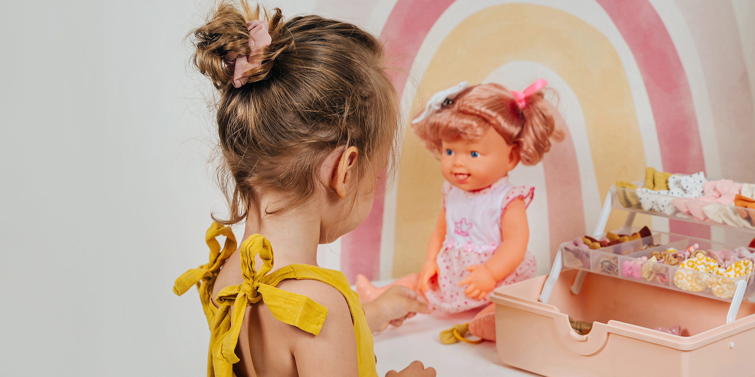 A girl playing with a doll | Source: Shutterstock