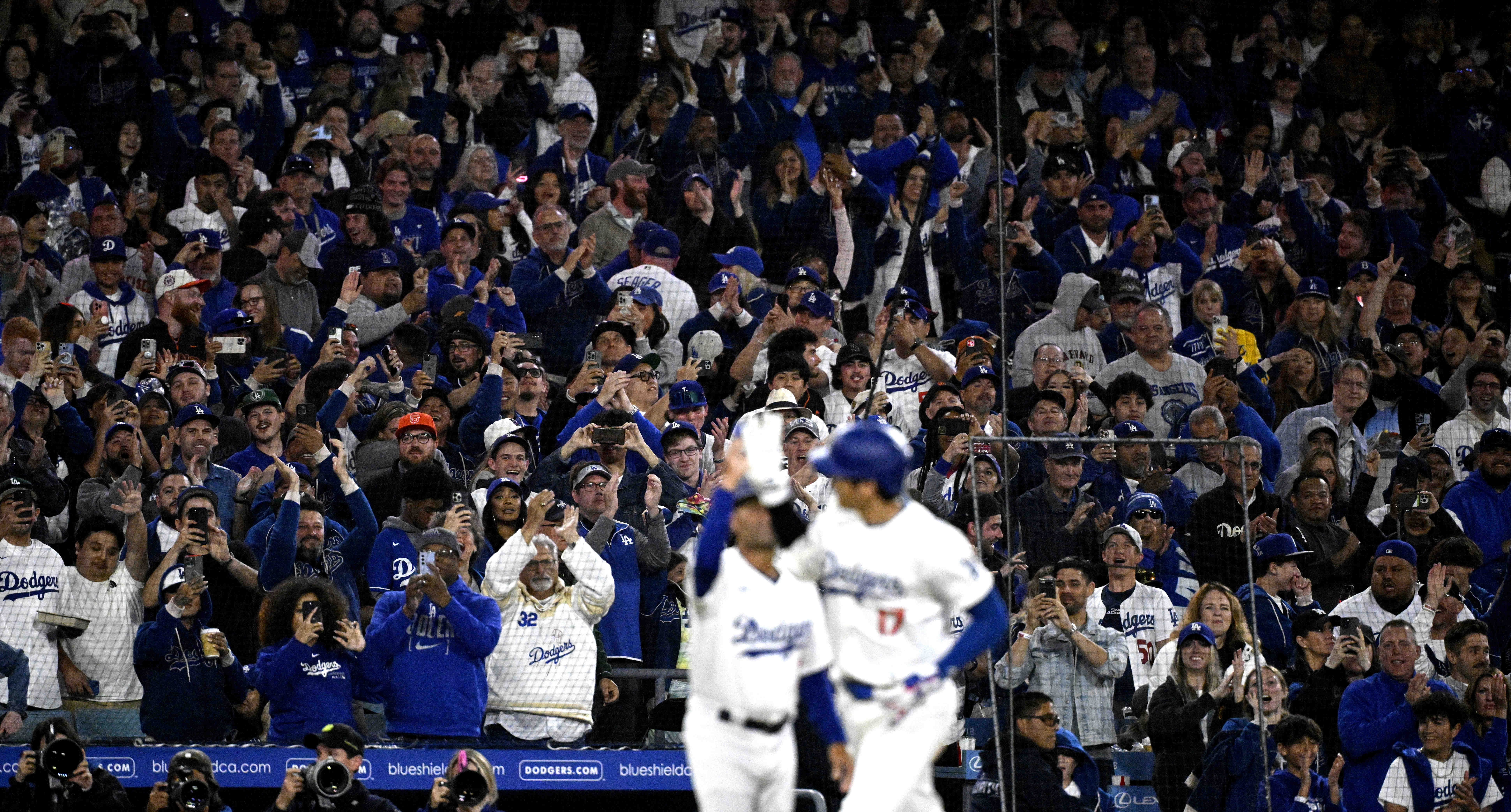 Fans react as Shohei Ohtani #17 of the Los Angeles Dodgers rounds third base after hitting a solo home run against the San Francisco Giants at Dodger Stadium in Los Angeles on April 3, 2024 | Source: Getty Images