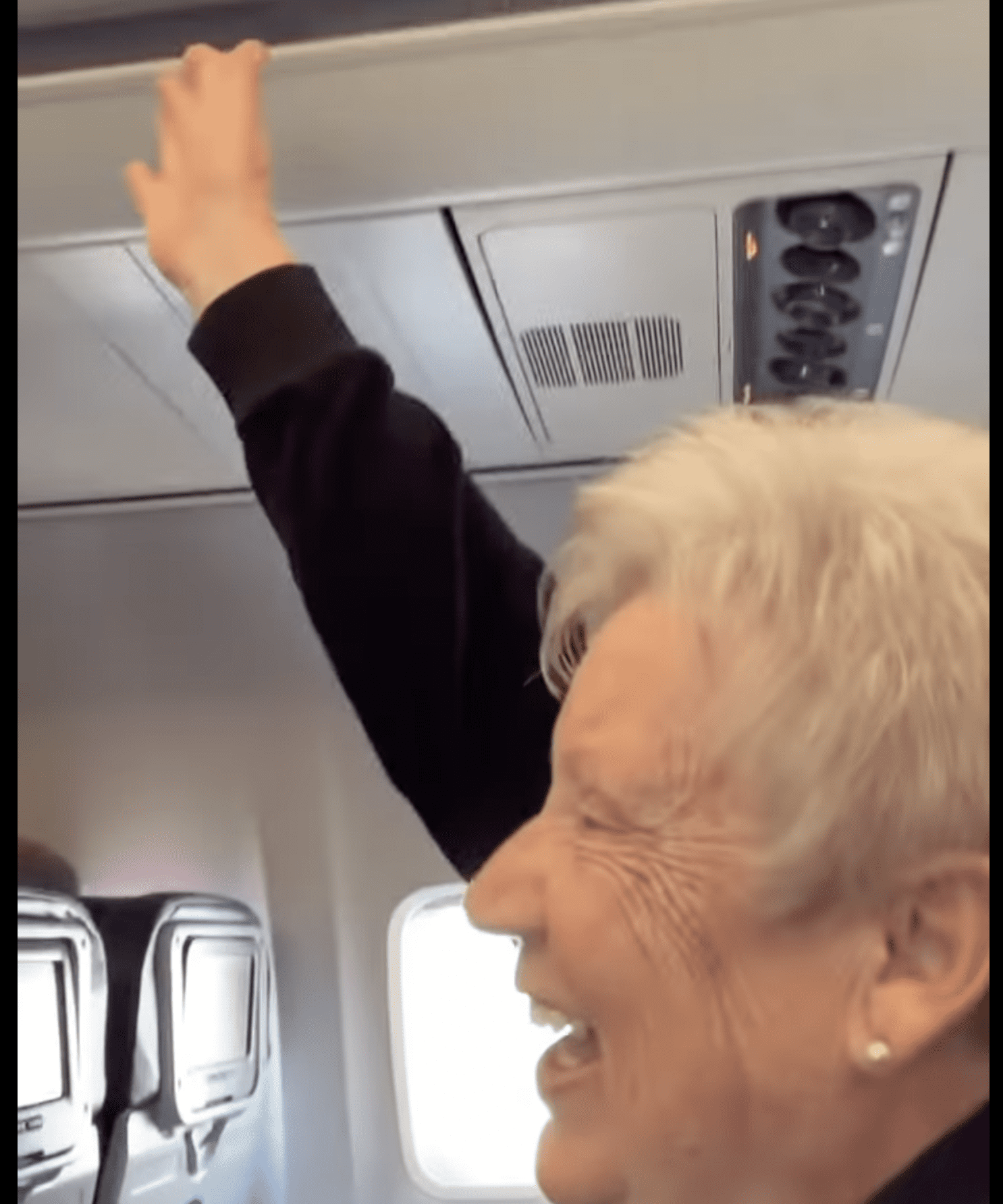 Michelle's mother raised her hand in response to the pilot's announcement. | Source: Youtube.com/Michelle A