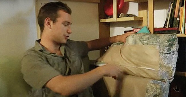 One of the roommates examining a pillow from the sofa | Photo: youtube.com/Associated Press  