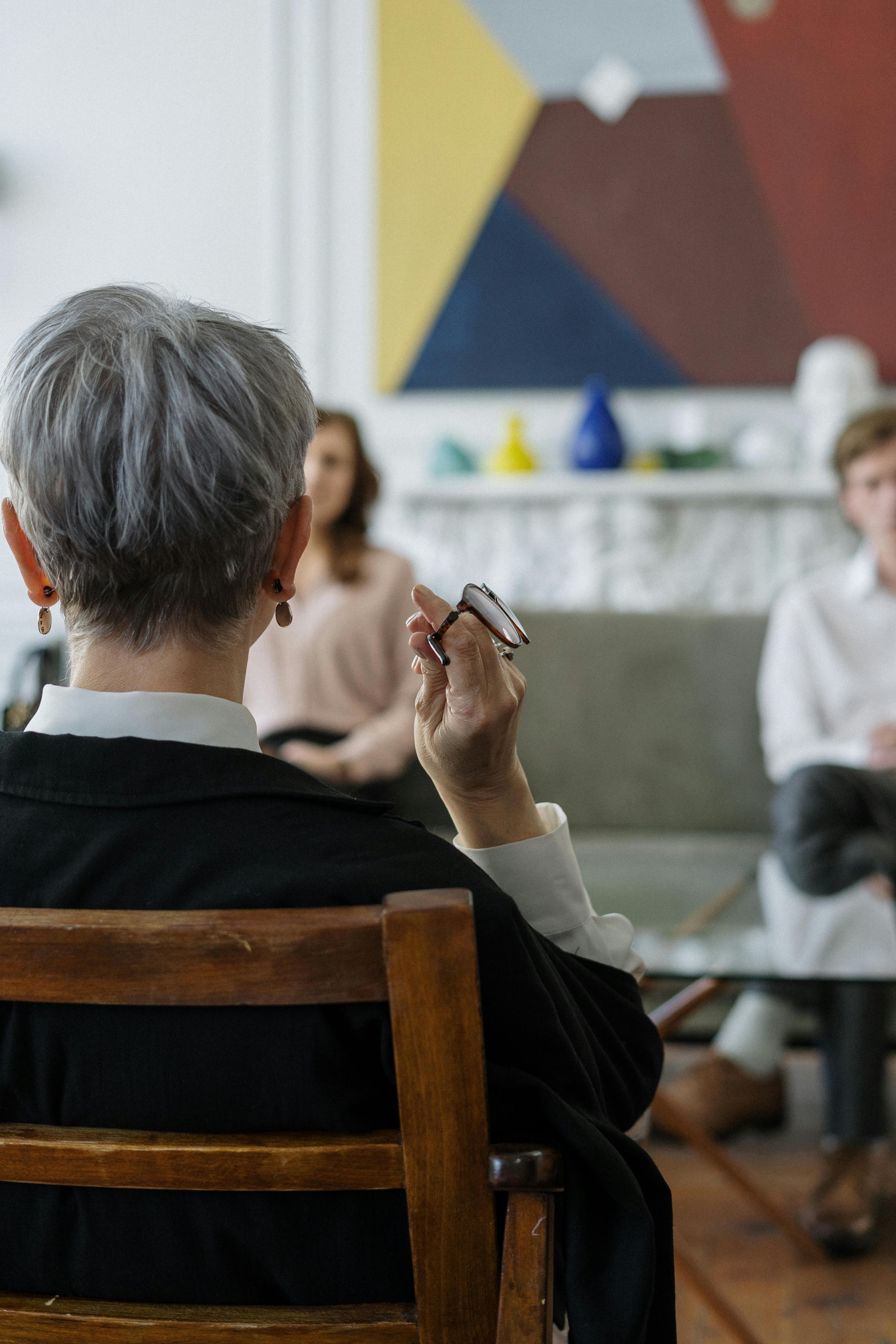 An older woman talking to a young couple | Source: Pexels