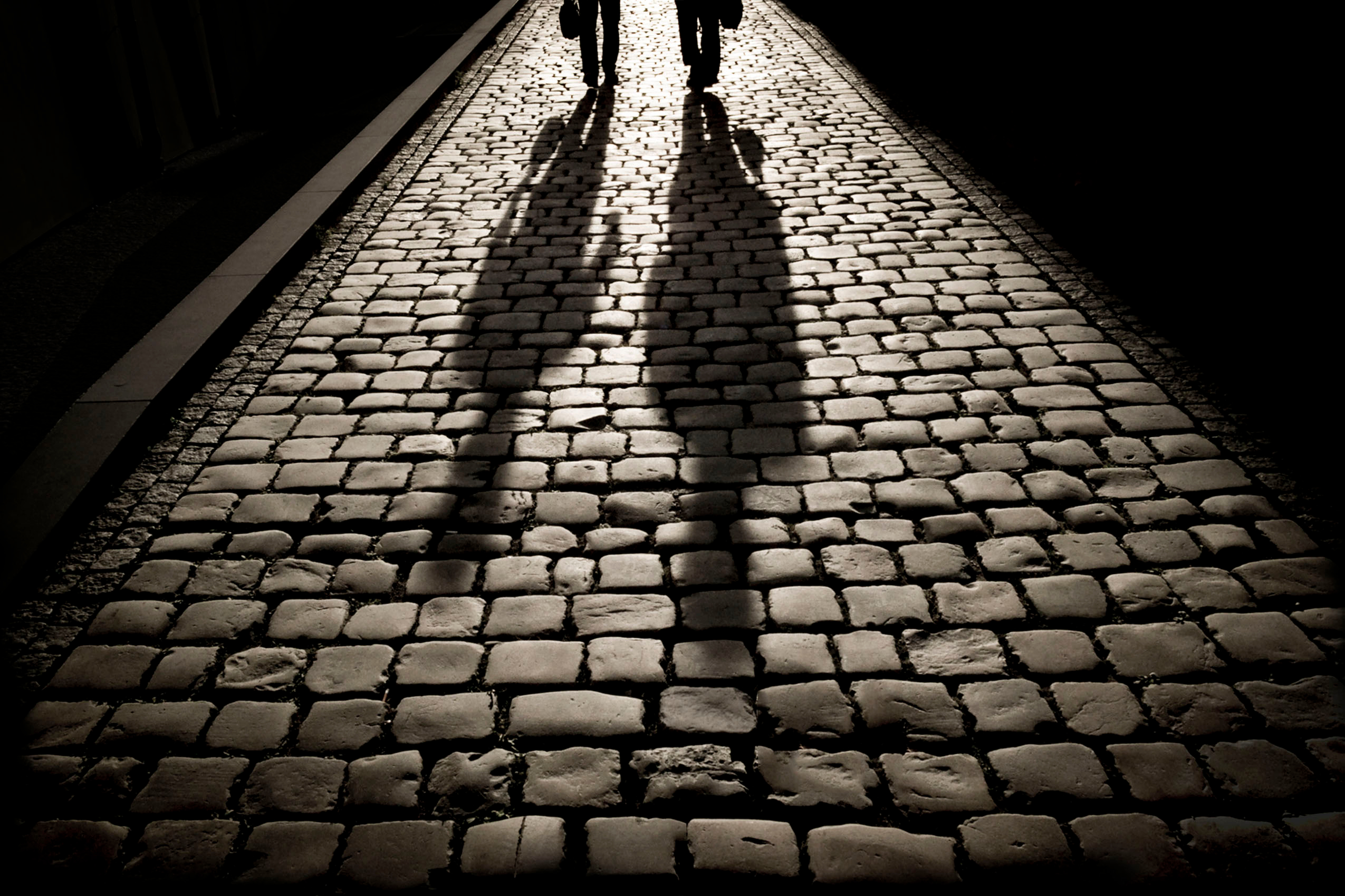 Two men walking on the pavement | Source: Shutterstock