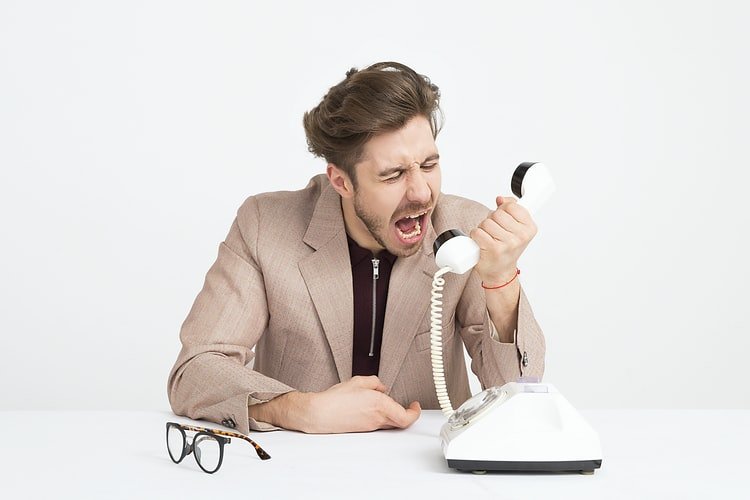 A man angrily answering the phone. | Photo: Unsplash.