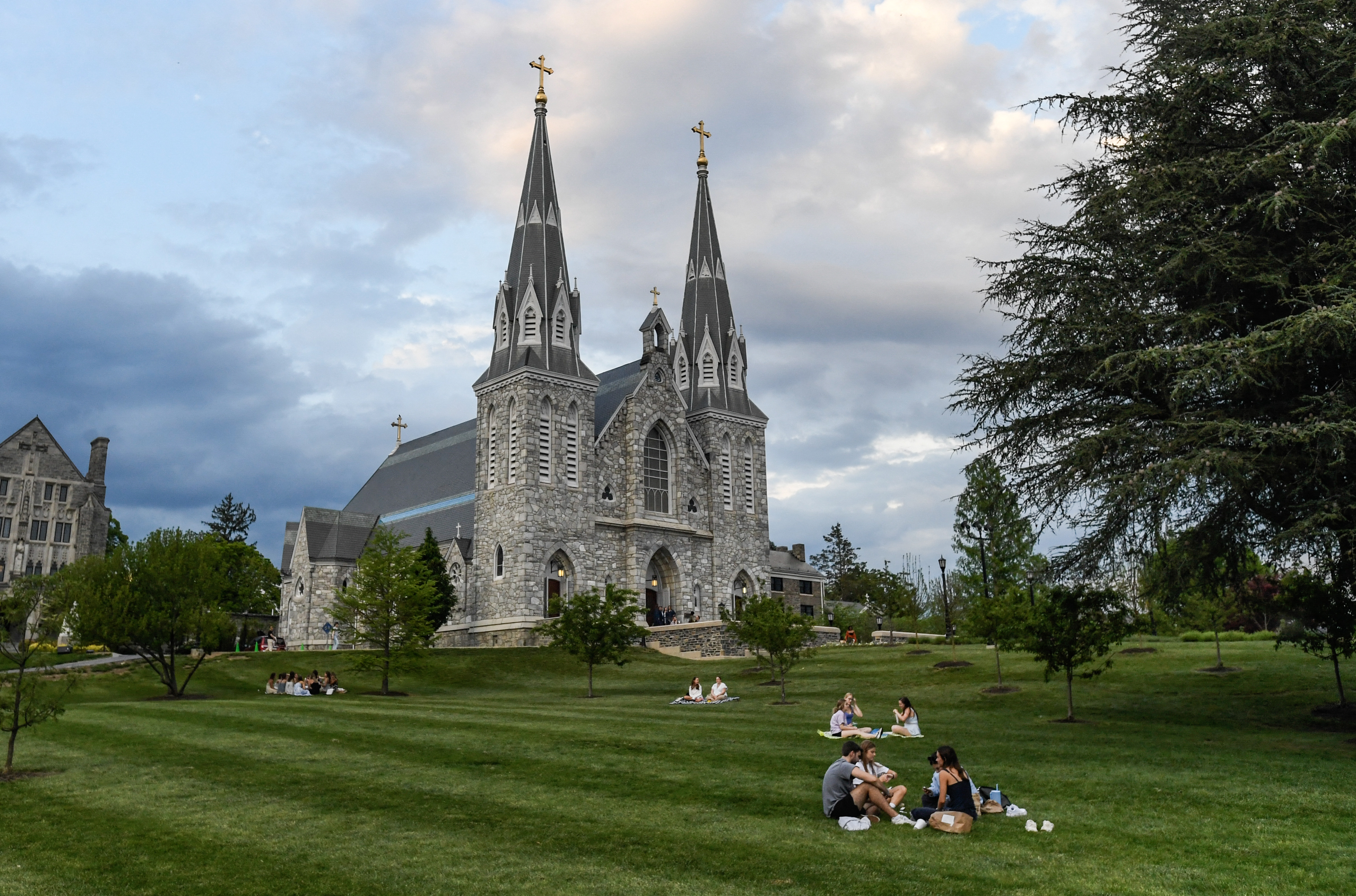 Students sit on the lawn outside of St. Thomas of Villanova Church at the campus of Villanova University in Pennsylvania on May 8, 2025 | Source: Getty Images