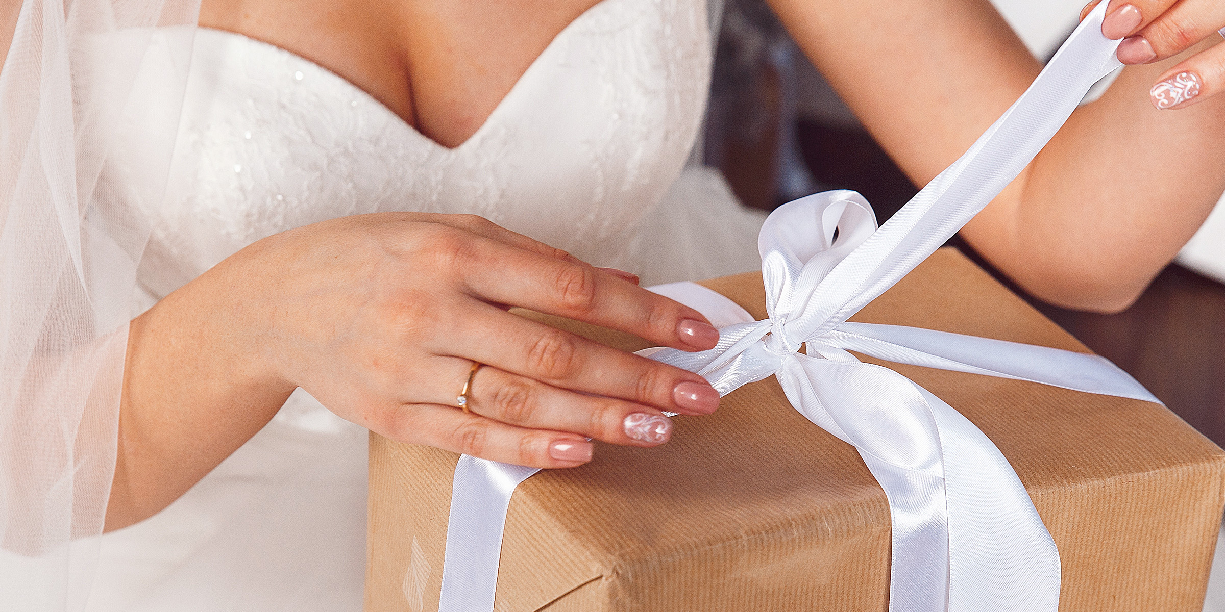 A bride unwrapping a gift | Source: Shutterstock