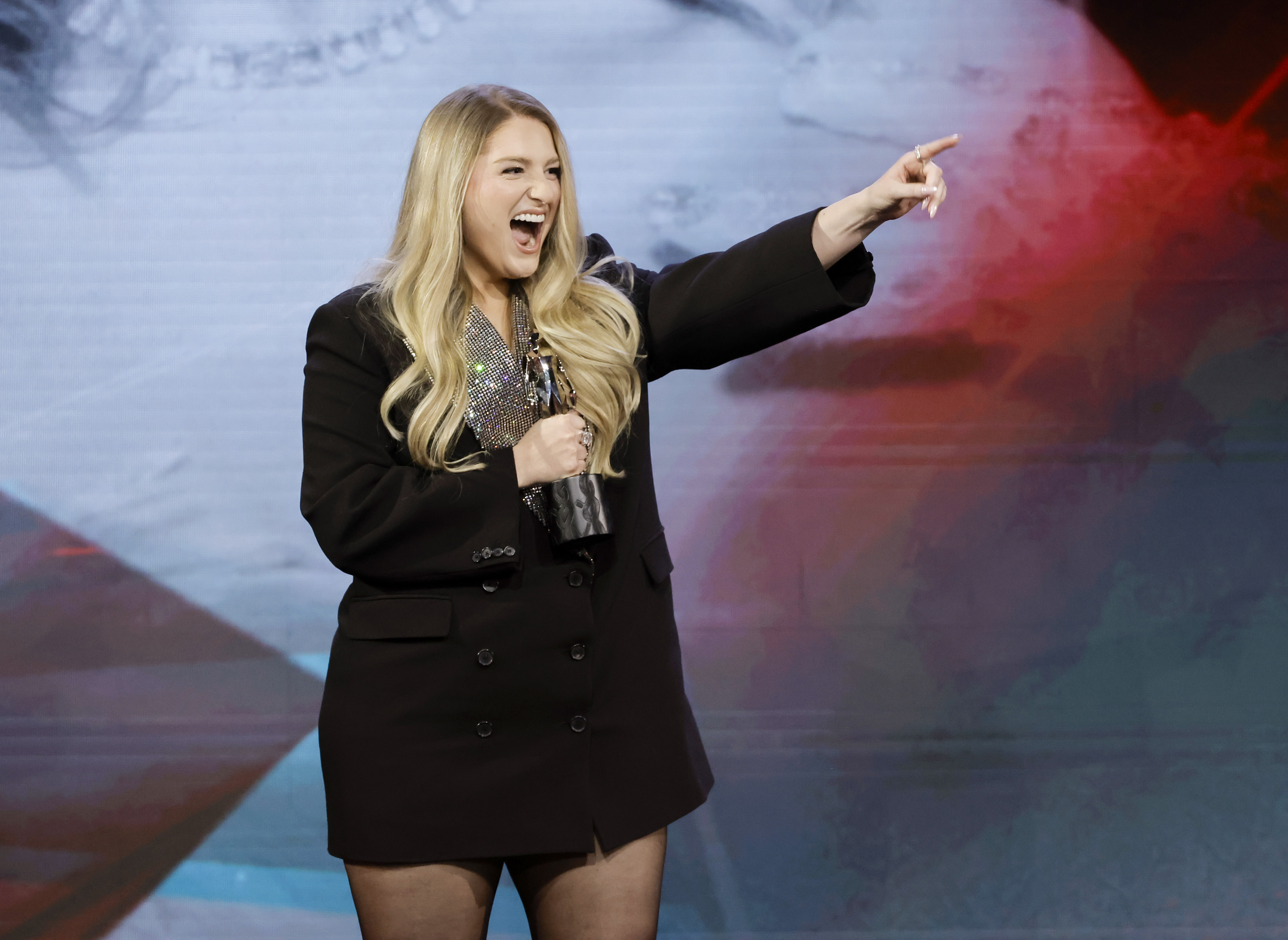 Meghan Trainor beams with excitement as she accepts the Rolling Stone Sound of the Year Award at the Streamy Awards in Los Angeles. Dressed in a chic oversized black blazer, she radiates confidence and joy while celebrating the milestone moment.