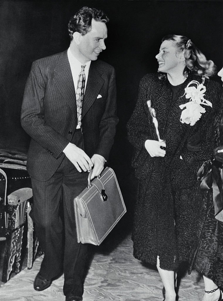 Ingrid Bergman holding her "Oscar" is accompanied by her husband Dr. Peter Lindstrom as they leave Hollywood's Grauman's Chinese Theatre | Source: Getty Images