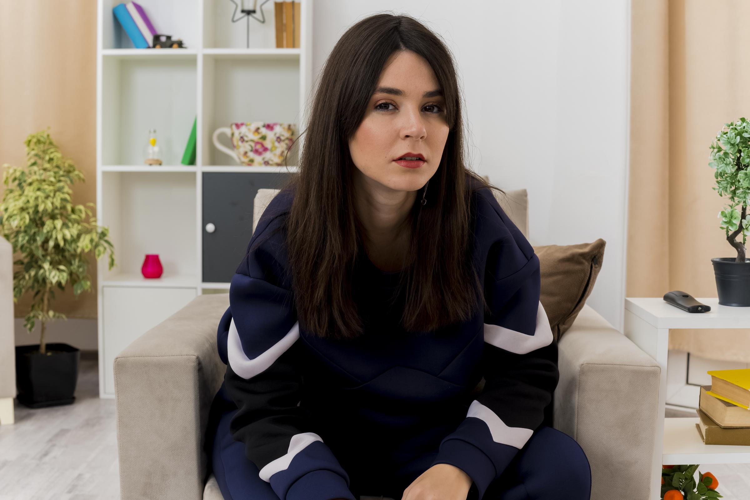 An angry young woman sitting on the couch | Source: Freepik