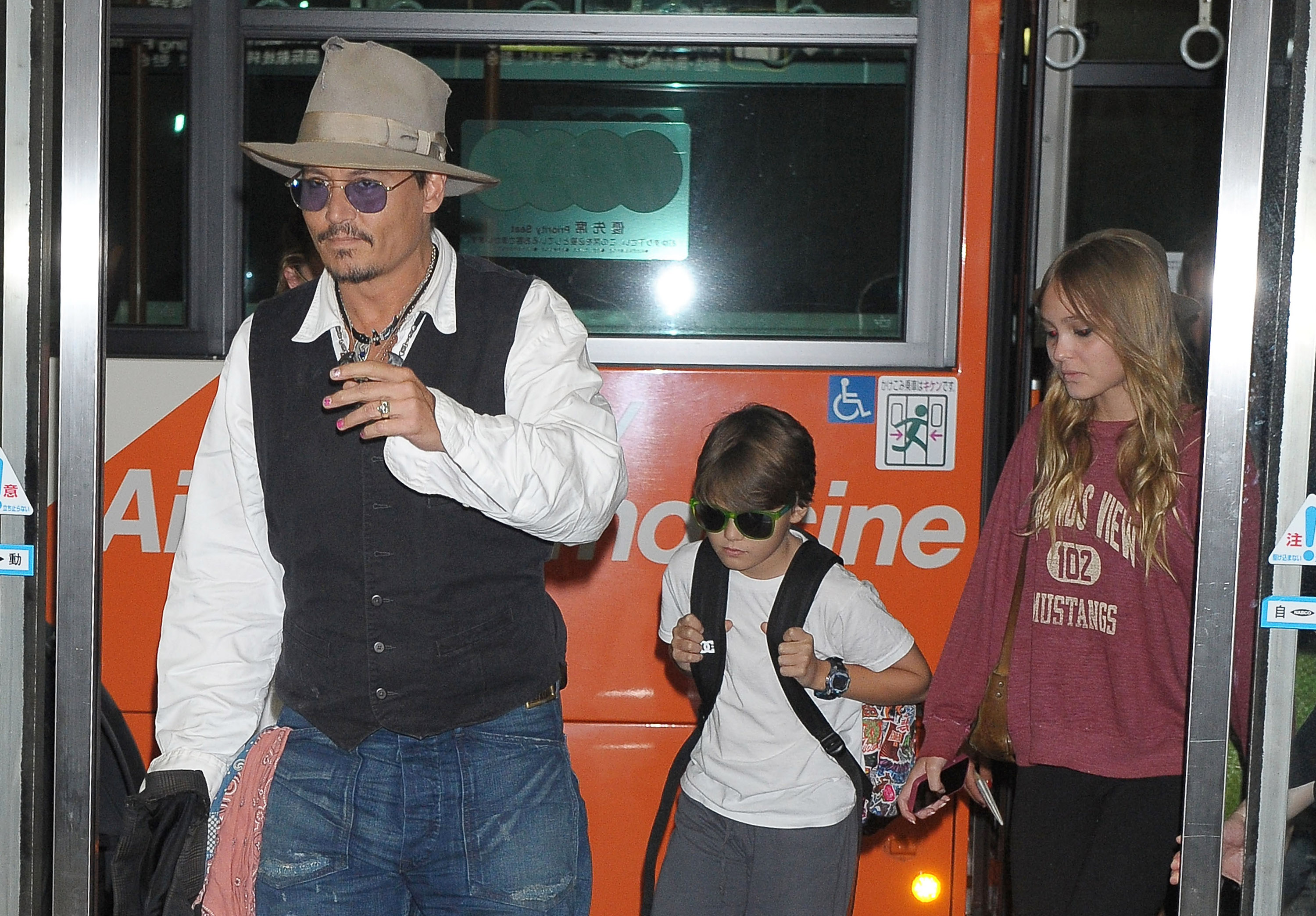Johnny Depp, Jack Depp, and Lily-Rose Melody Depp at Narita International Airport on July 16, 2013, in Narita, Japan | Source: Getty Images