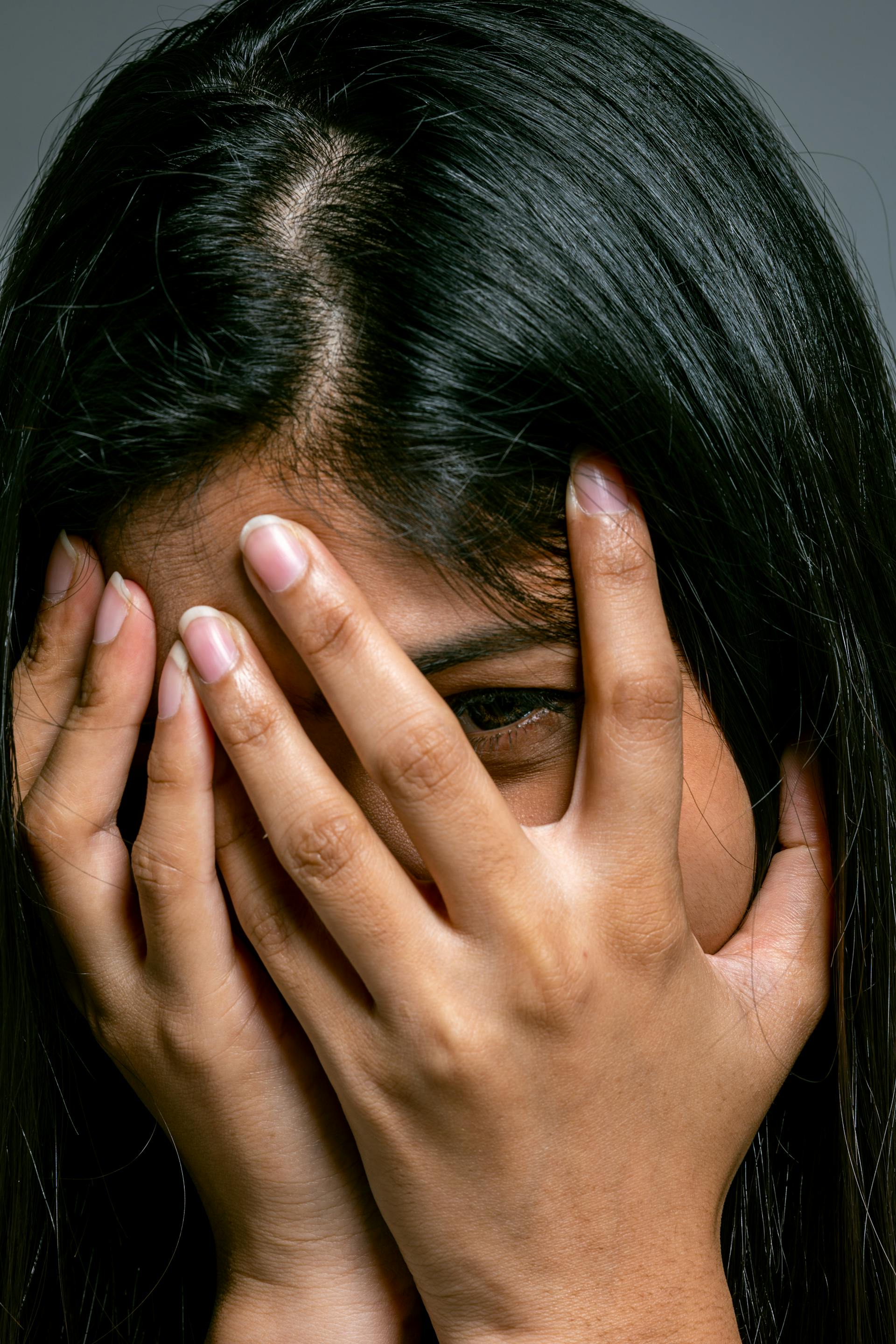 A woman hiding her face | Source: Pexels