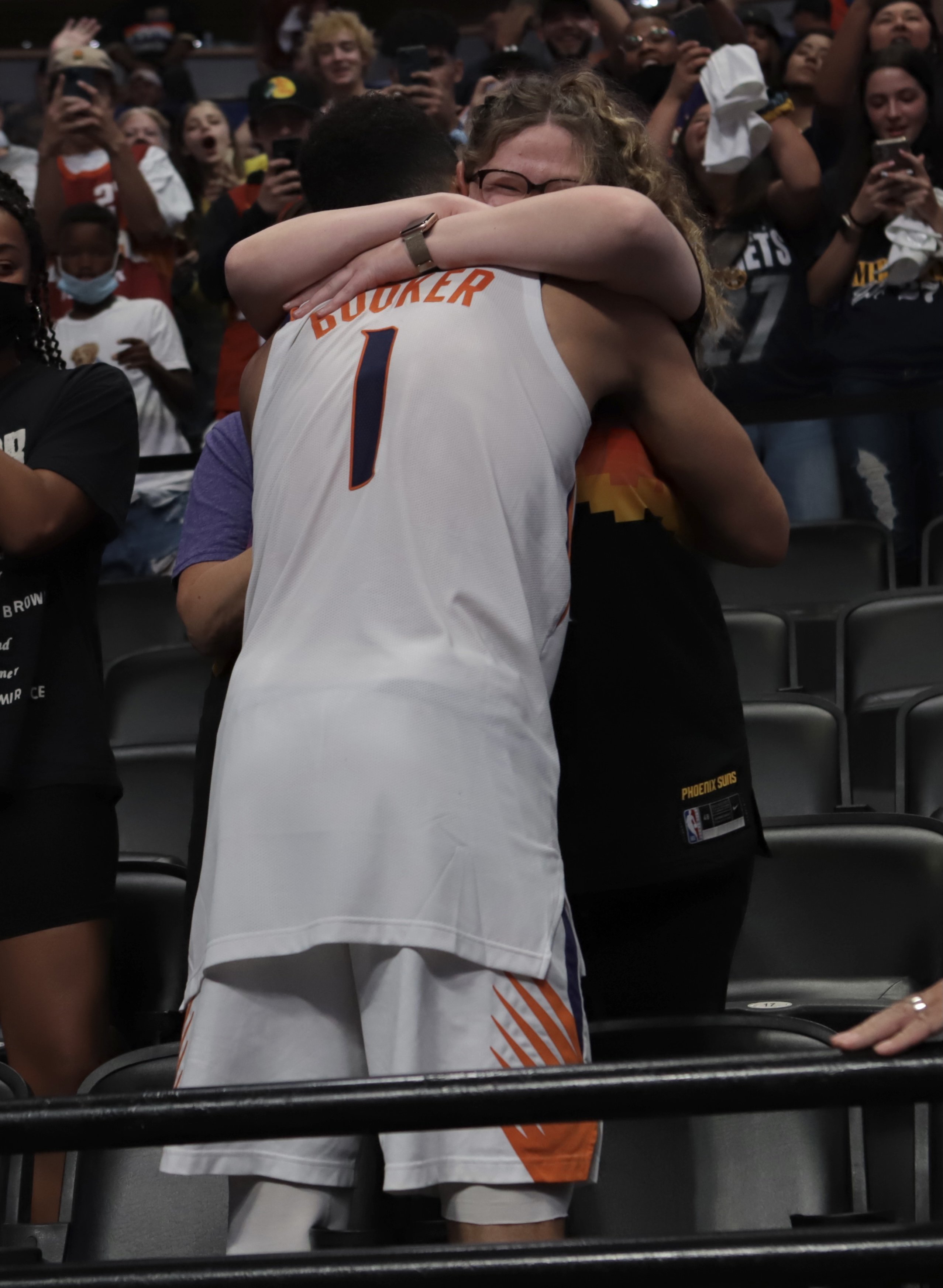 Devin Booker hugs his Mya Powell after the game against the Denver Nuggets during Round 2, Game 4 of the 2021 NBA Playoffs on June 13, 2021 at the Ball Arena in Denver, Colorado. | Source: Getty Images