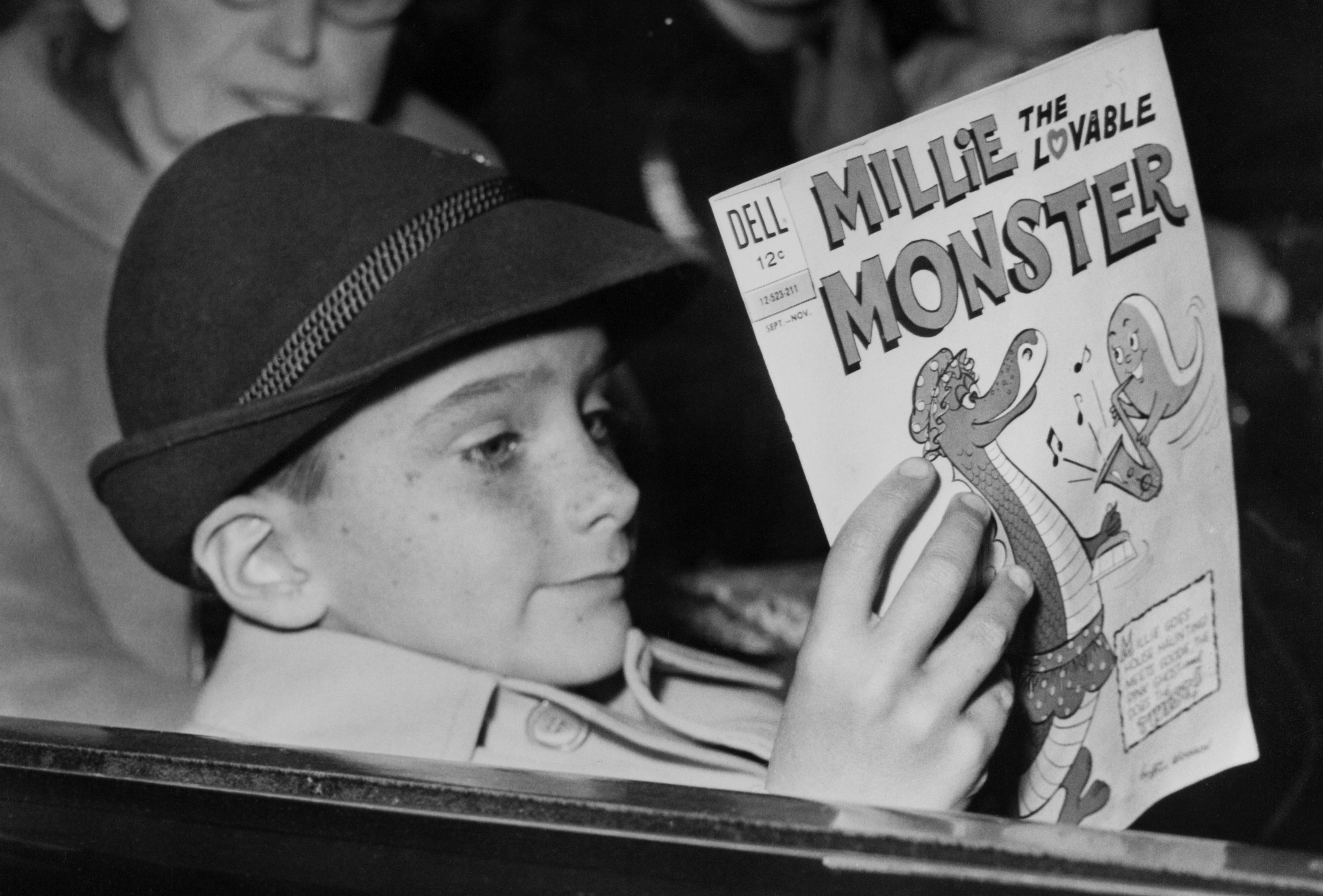 Christopher Wilding reads a comic on December 17, 1962, in London, England. | Source: Getty Images