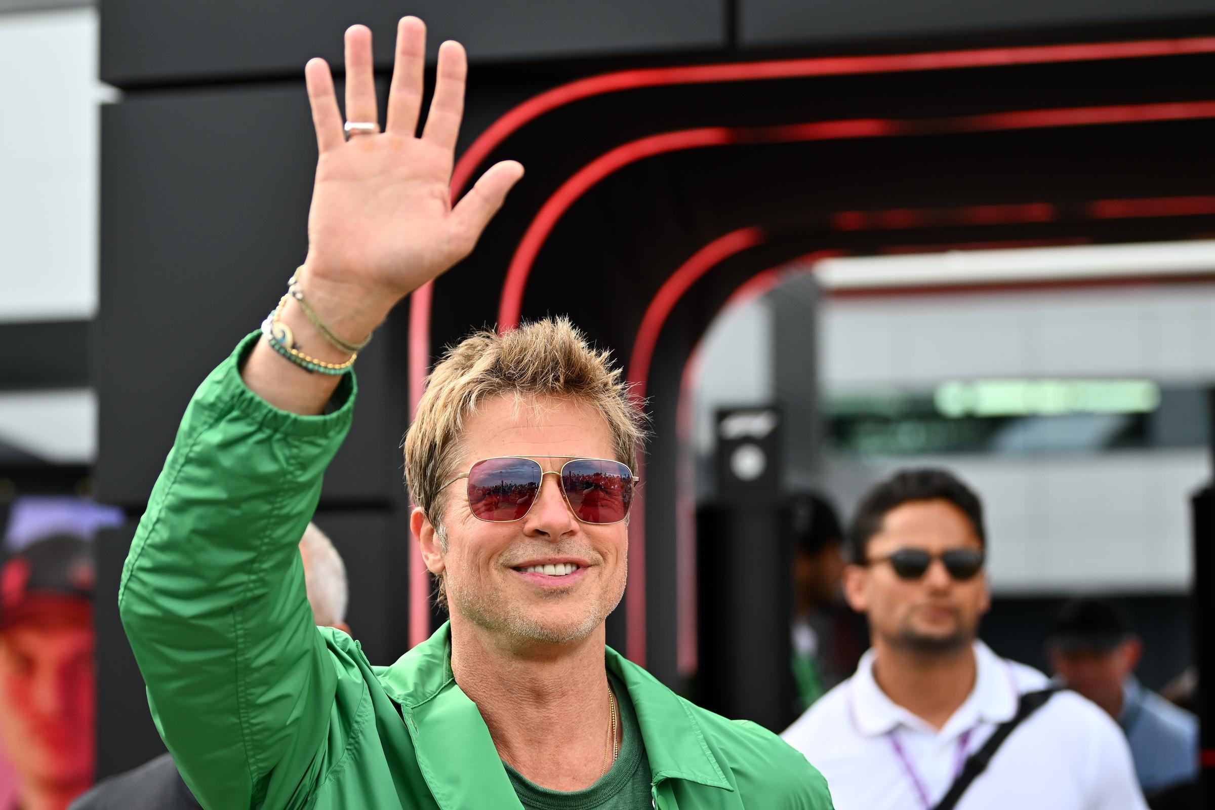 Brad Pitt waves while walking in the Paddock after qualifying for the F1 Grand Prix of Great Britain at Silverstone Circuit in Northampton, England on July 8, 2023. | Source: Getty Images