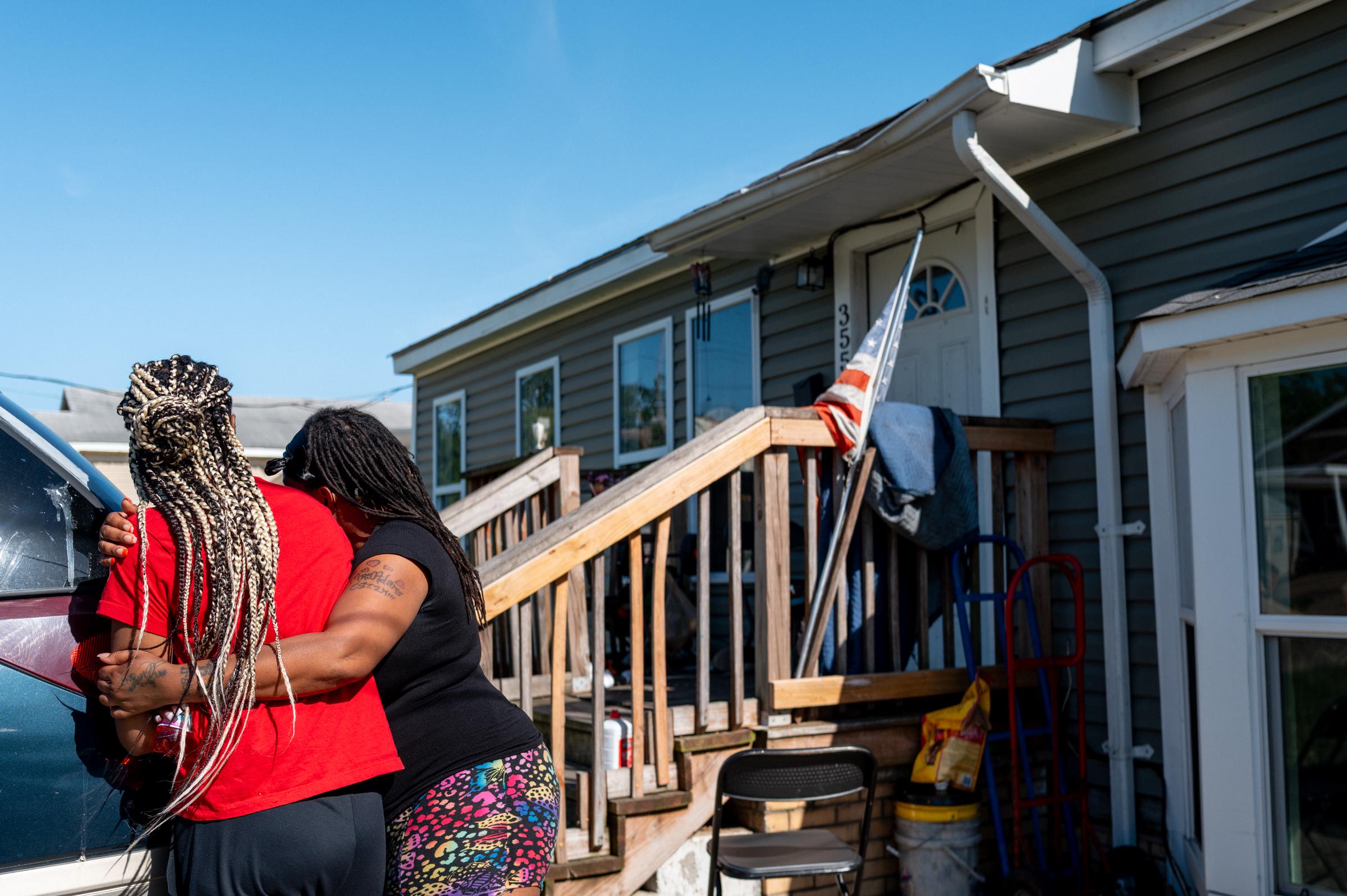A woman is comforted while grieving the loss of family members after the shooting in Shreveport, Louisiana. | Source: Getty Images