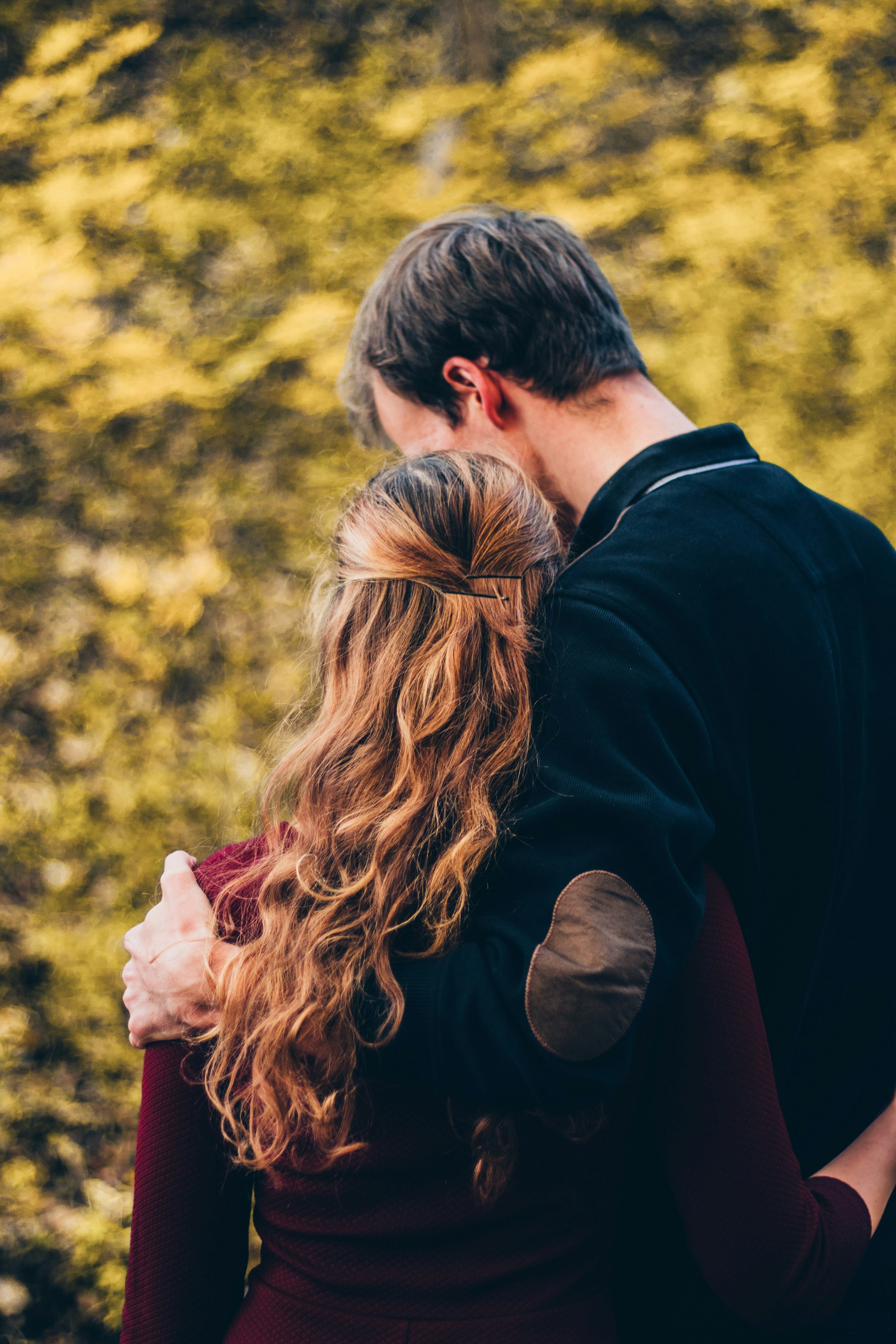 Rear shot of a couple embracing each other | Source: Unsplash