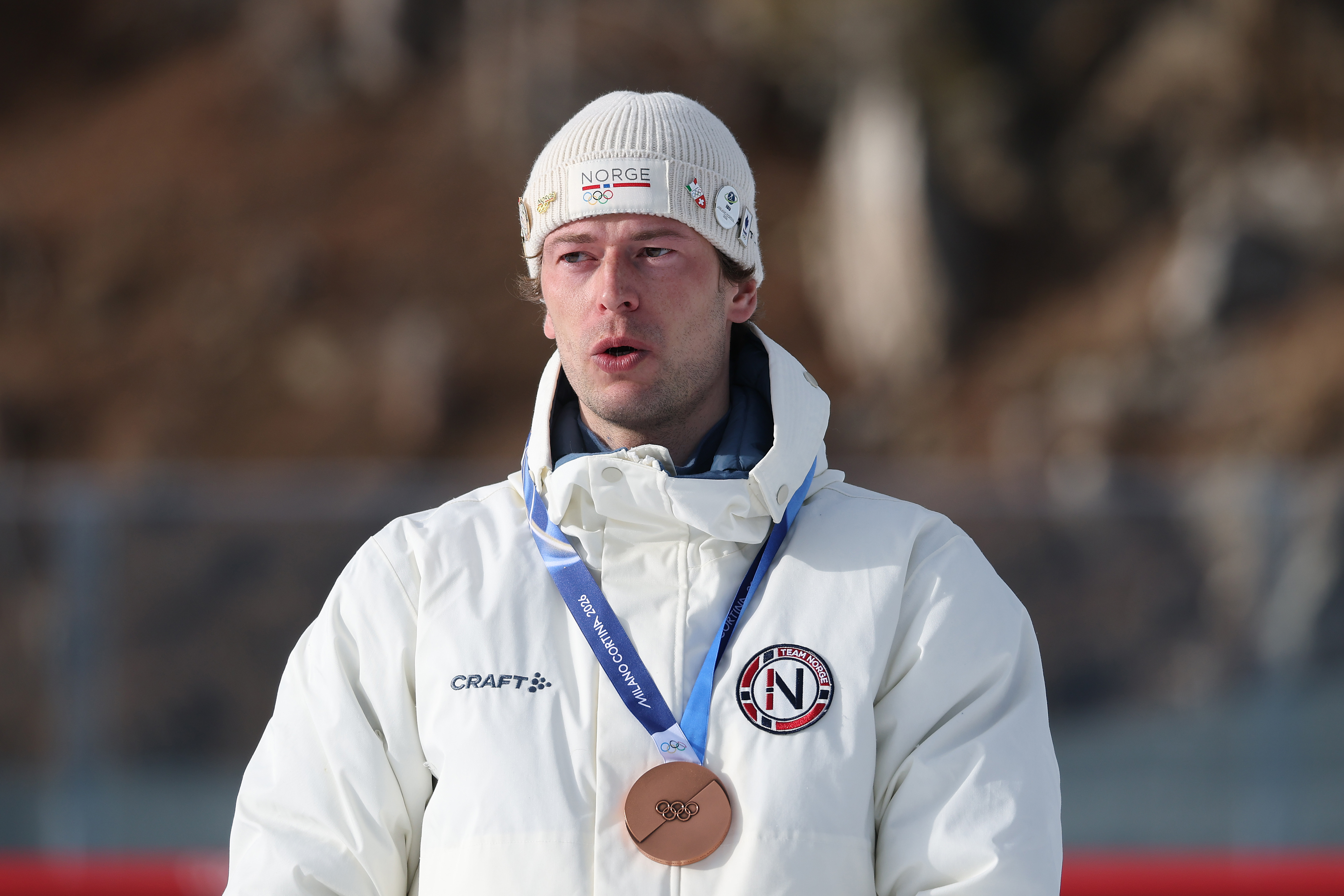 Sturla Holm Laegreid of Team Norway reacts on the podium during the men’s 20km individual medal ceremony at the Milano Cortina 2026 Winter Olympic Games in Italy on February 10. | Source: Getty Images