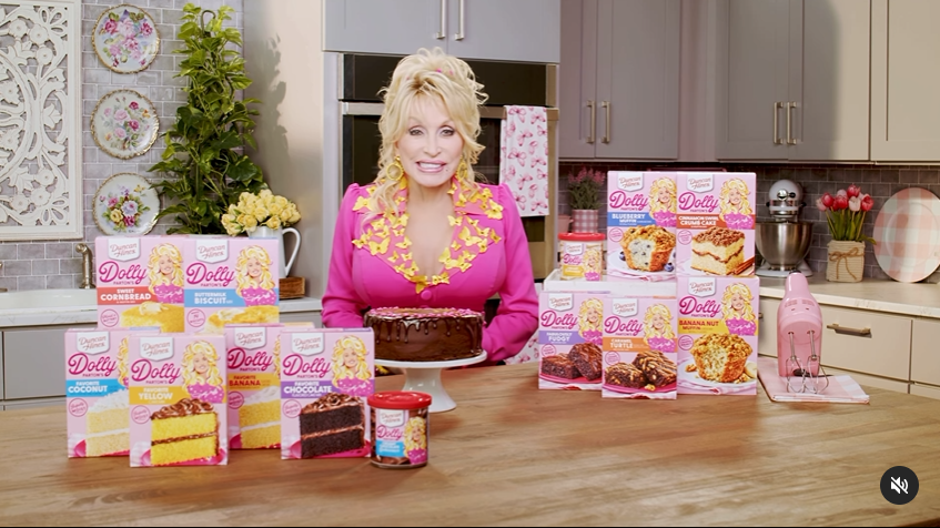 A screenshot captures Dolly Parton showcasing an array of her baking mix items.  | Source: Instagram/dollyparton