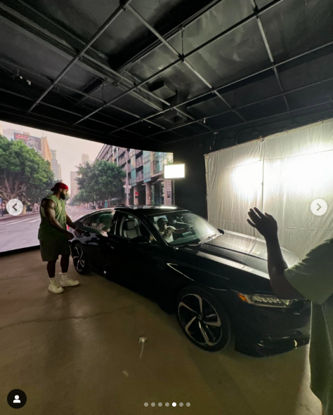 An actor opening a car door while another actor sits inside the vehicle. | Source: Instagram/alyshaburney_