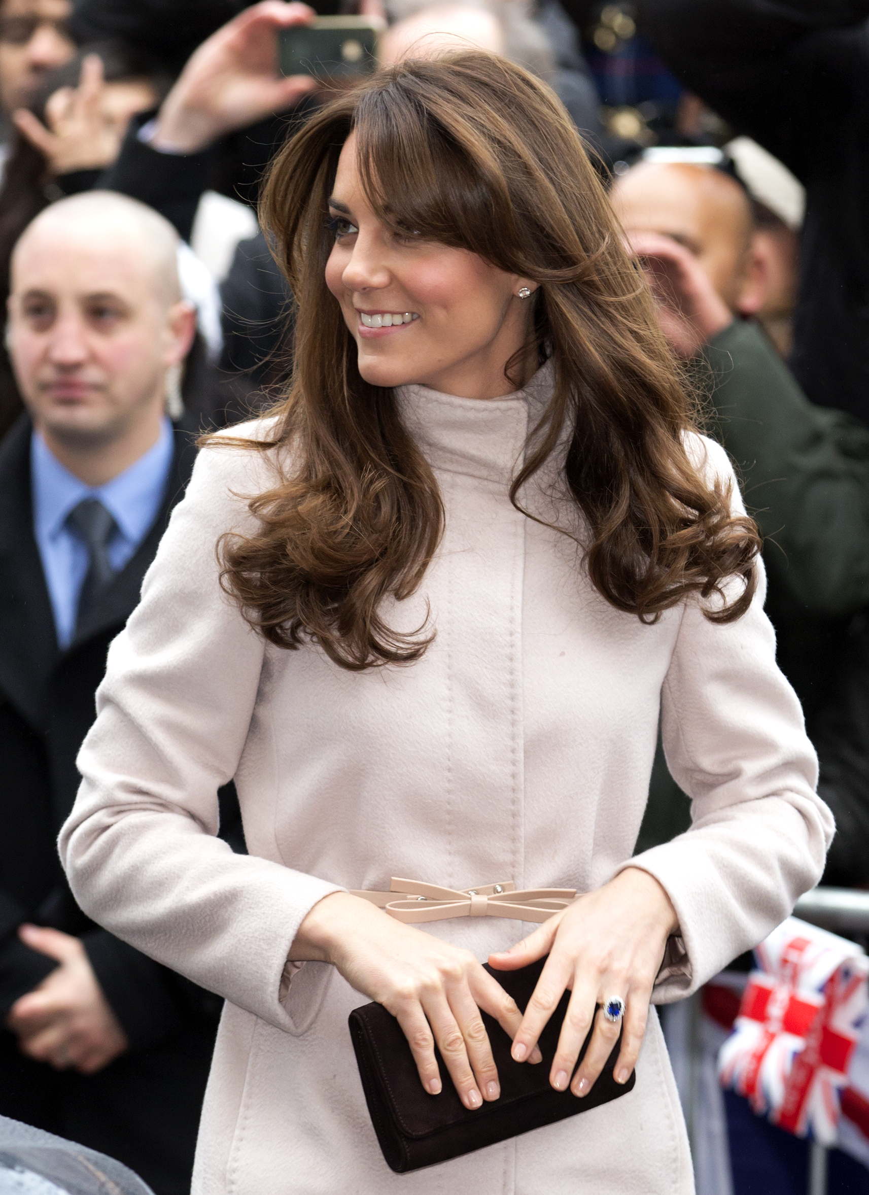 Catherine, Duchess of Cambridge, arrives at The Guildhall during her and Prince William’s first official visit to Cambridge. She wore her signature brunette hair styled in soft curly waves.