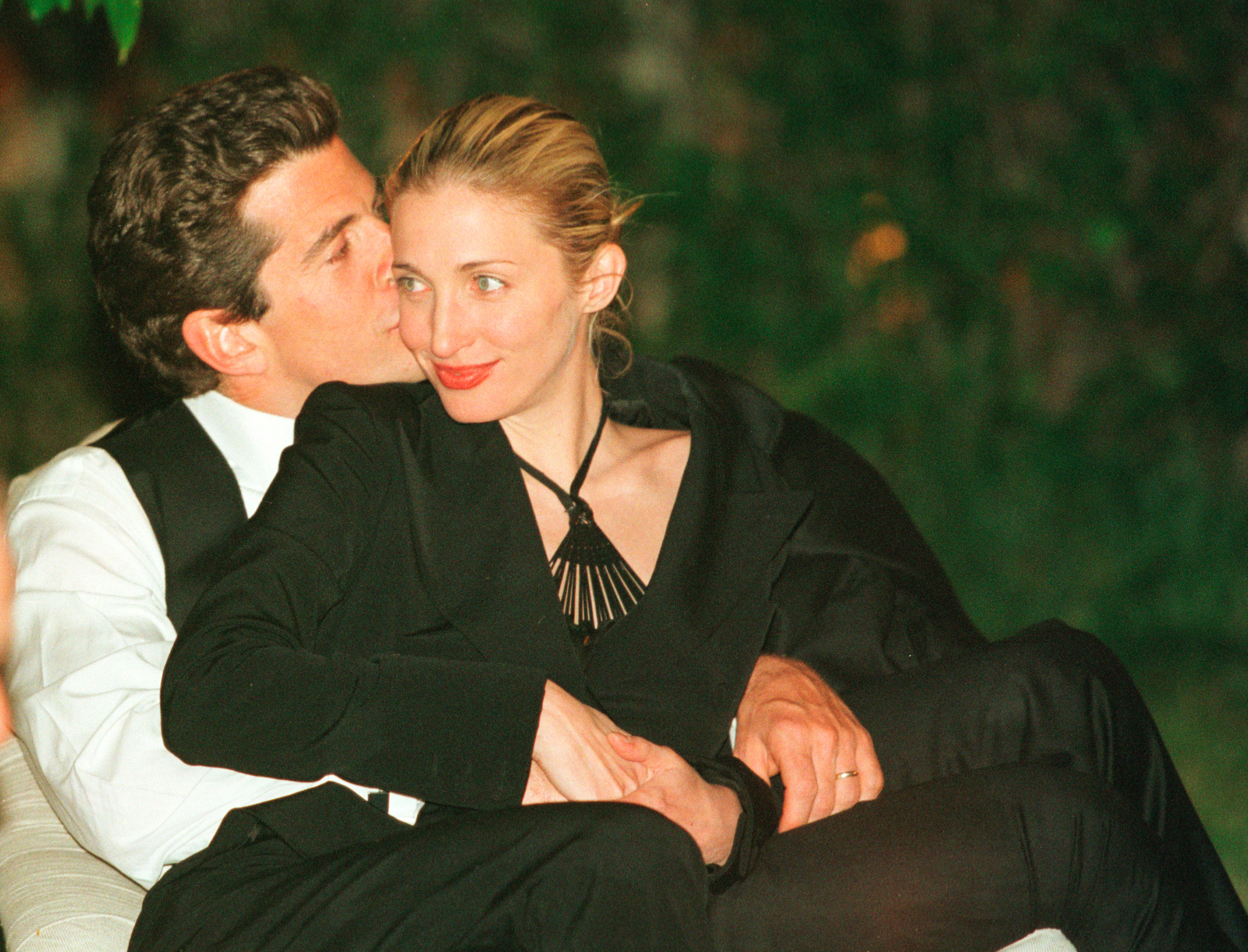 John F. Kennedy Jr. planting a kiss on Carolyn Bessette-Kennedy's cheek at the annual White House Correspondents dinner on May 1, 1999, in Washington, D.C. | Source: Getty Images