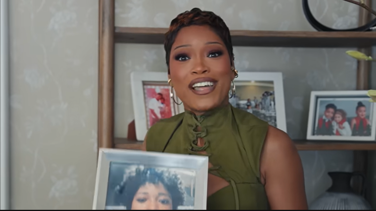 Palmer grabs one of the infamous framed photos off her shelf, ready to explain why her house is full of solo portraits. | Source: YouTube/@Archdigest