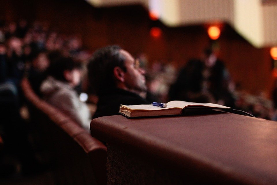 Men listening attentively at a seminar program | Photo: Pixabay
