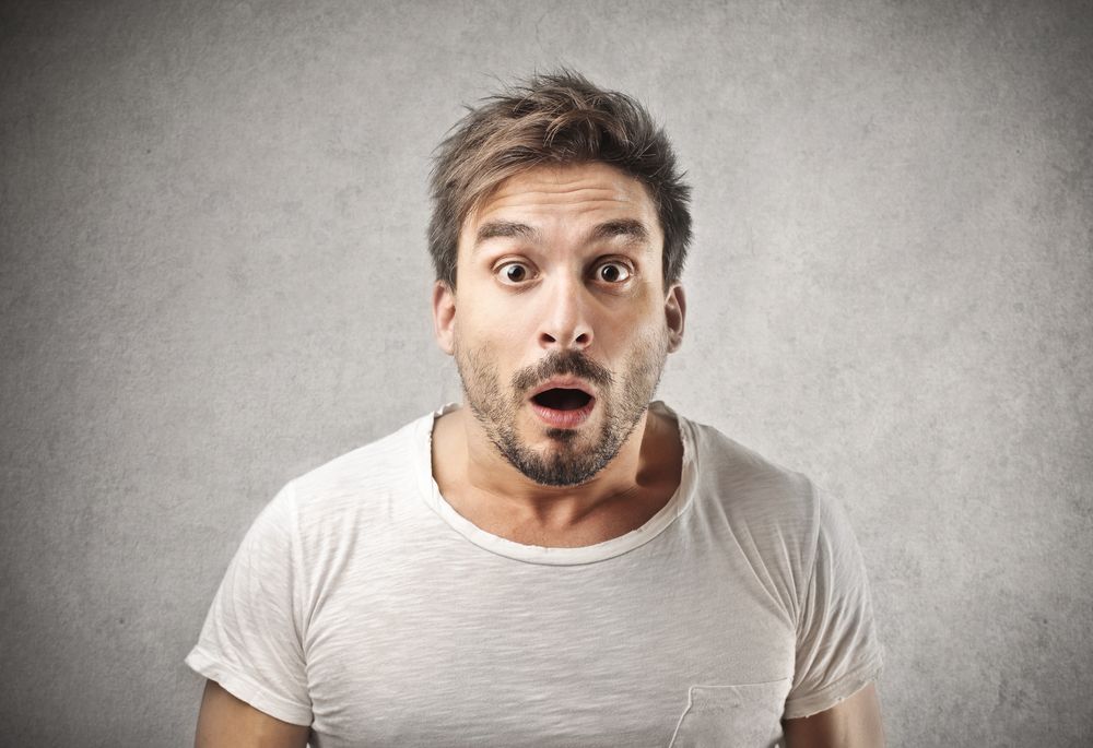 A man looks shocked as he faces the camera. | Source: Shutterstock