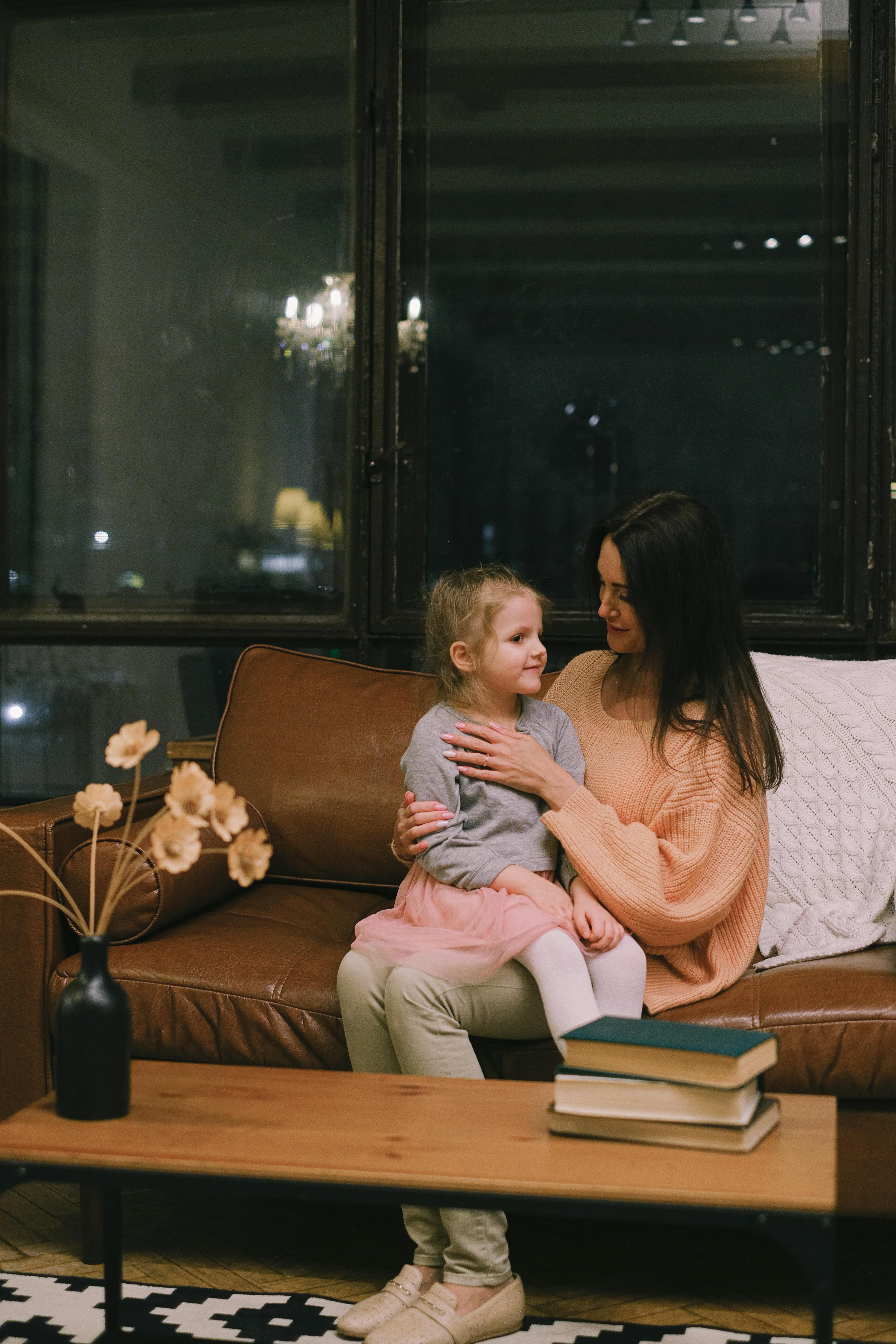 Little girl on her mother's lap | Source: Pexels