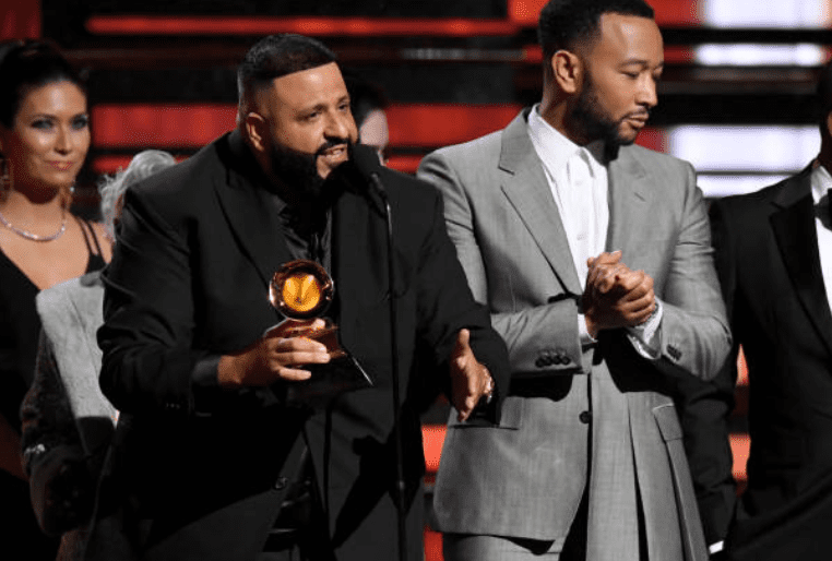DJ Khaled accepts his first Grammy award while standing next to John Legend for the Best Rap/Sung Performance award for their son 'Higher' at the 62nd Grammy Awards on January 26, 2020, in Los Angeles, California | Source: Getty Images (Photo by Jeff Kravitz/FilmMagic)